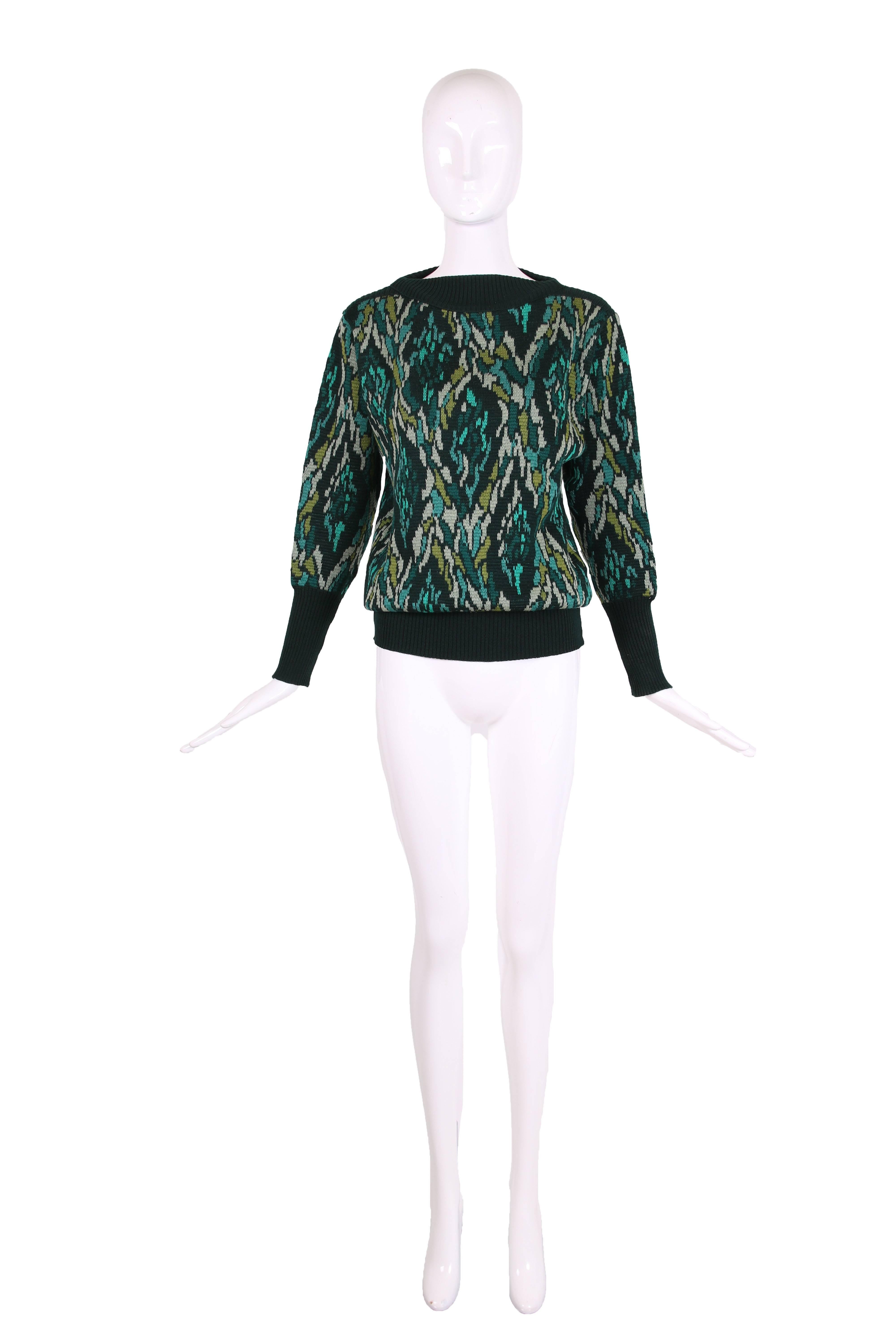 Vintage Yves Saint Laurent abstract patterned knit sweater in shades of blue and green. Dark green ribbing at neckline, cuffs and hem. Sweater is in excellent condition - label is cut out in the middle but is clearly Yves Saint Laurent based on the