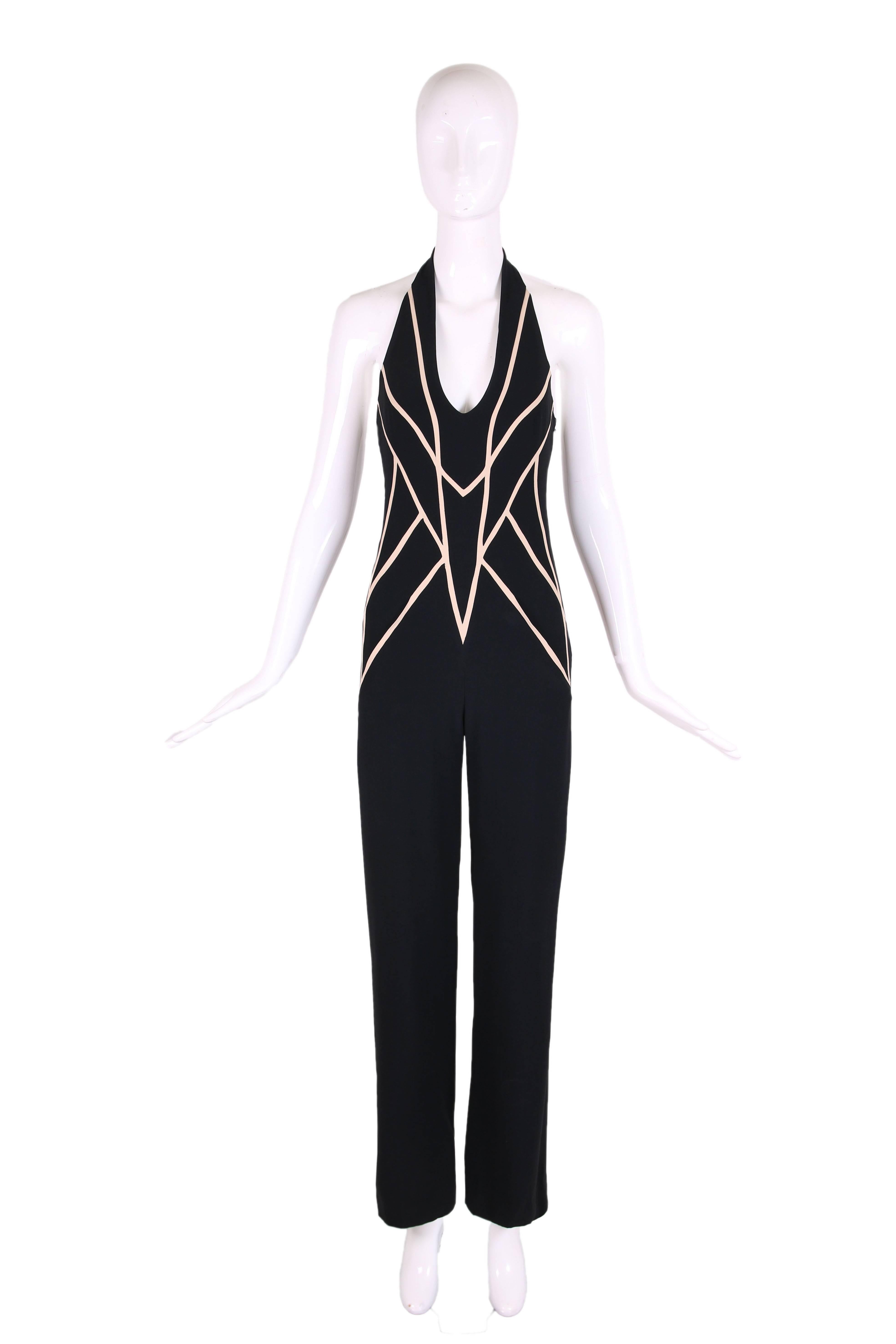 2008 Alexander McQueen black halter jumpsuit with cream-colored geometric motif at top front and back. Side zipper closure, and hook and eye closure at back neck. Fully lined. Fabric tag says acetate and viscose blend. Size UK38. In excellent