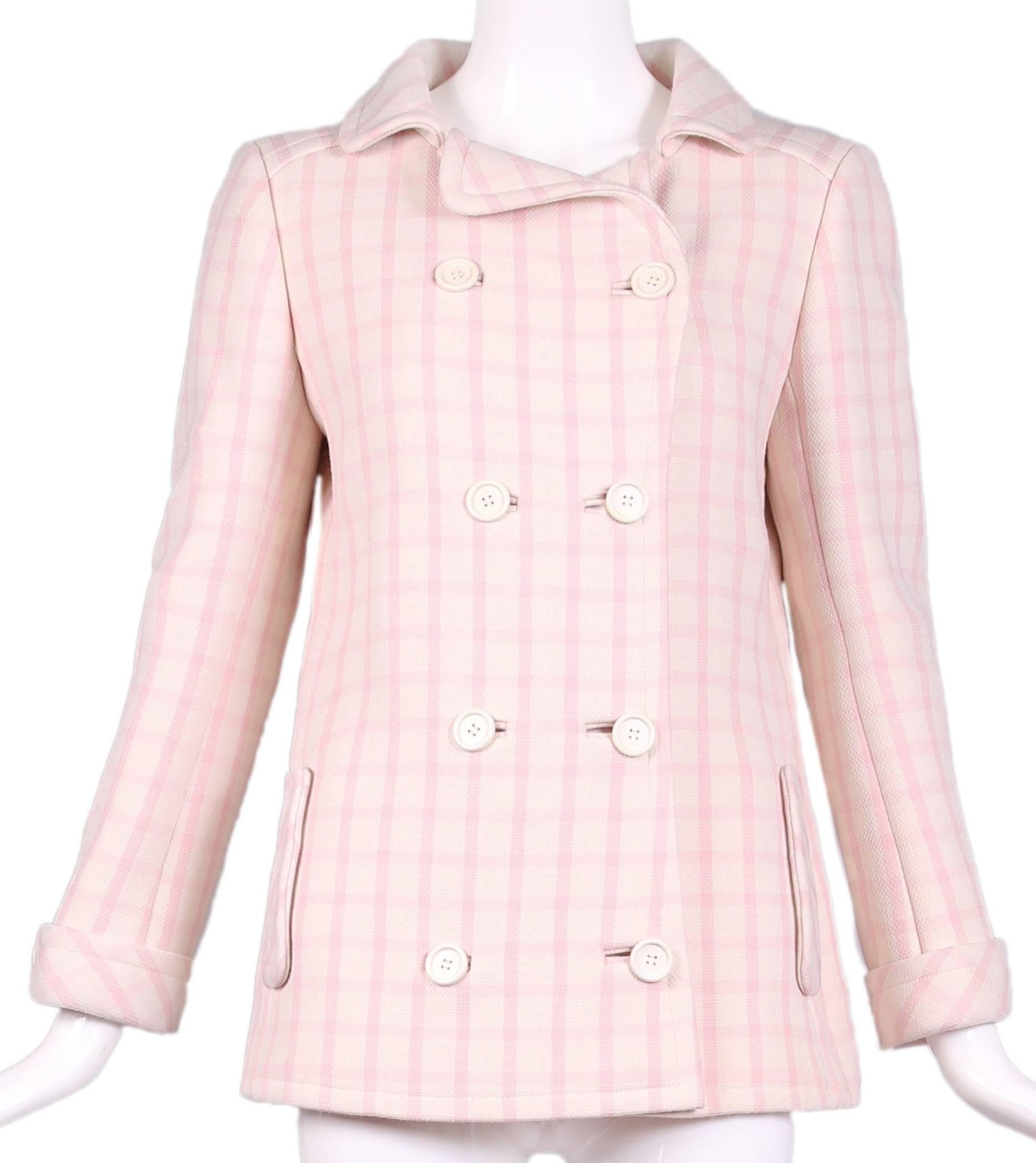 A 1968 Andre Courrèges for Harrods pink and white checked wool double-breasted jacket with rear belt. Contains two side pockets with flaps and lined entirely in white rayon. In excellent condition with a few yellow spots at the interior lining. No