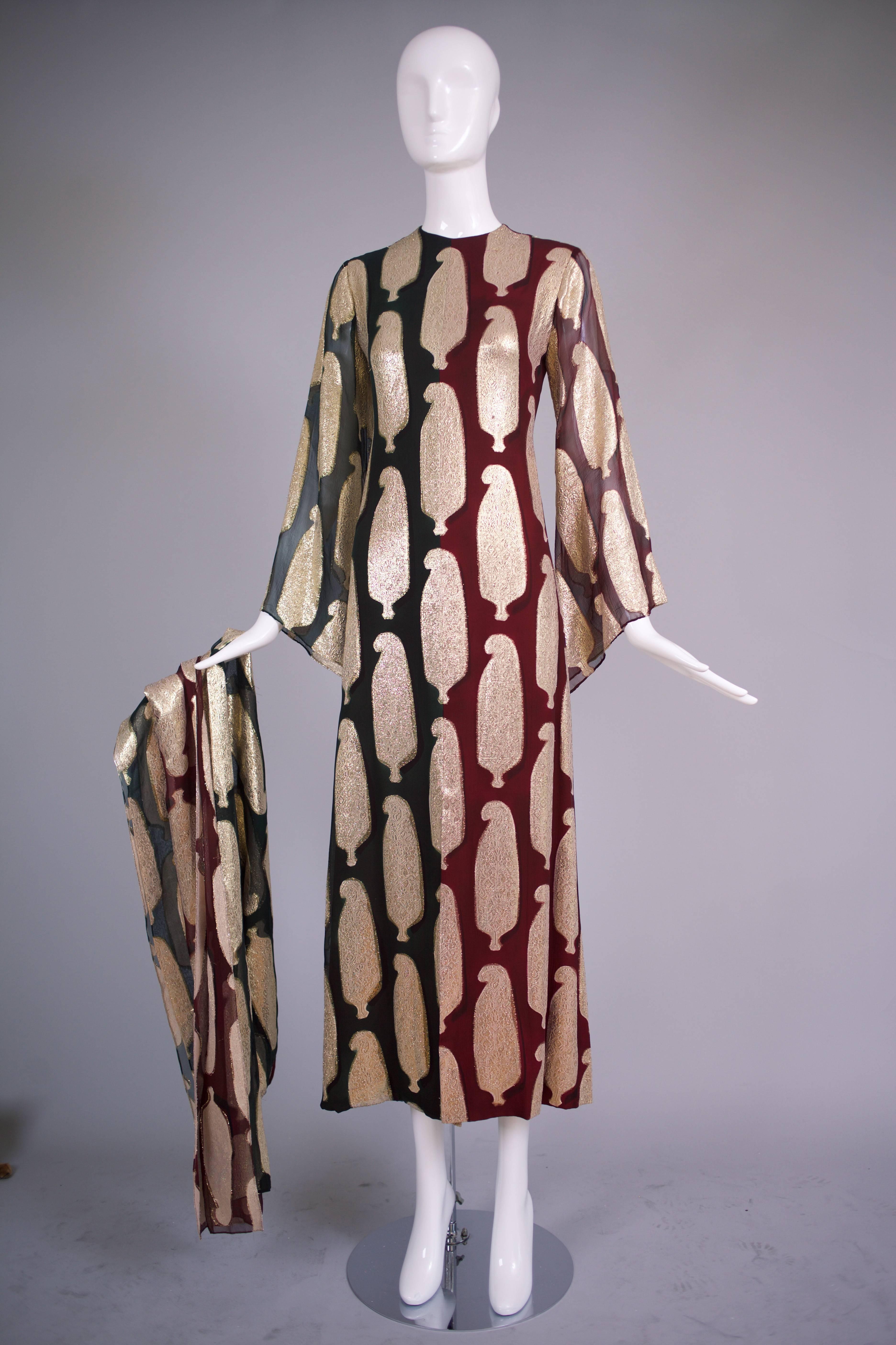 1971 Bill Blass burgundy red and hunter green chiffon and paisley gold lame gown with matching scarf. The gown is divided into two colors on its vertical axis - hunter green chiffon on the right and burgundy red chiffon on the left  half. Design