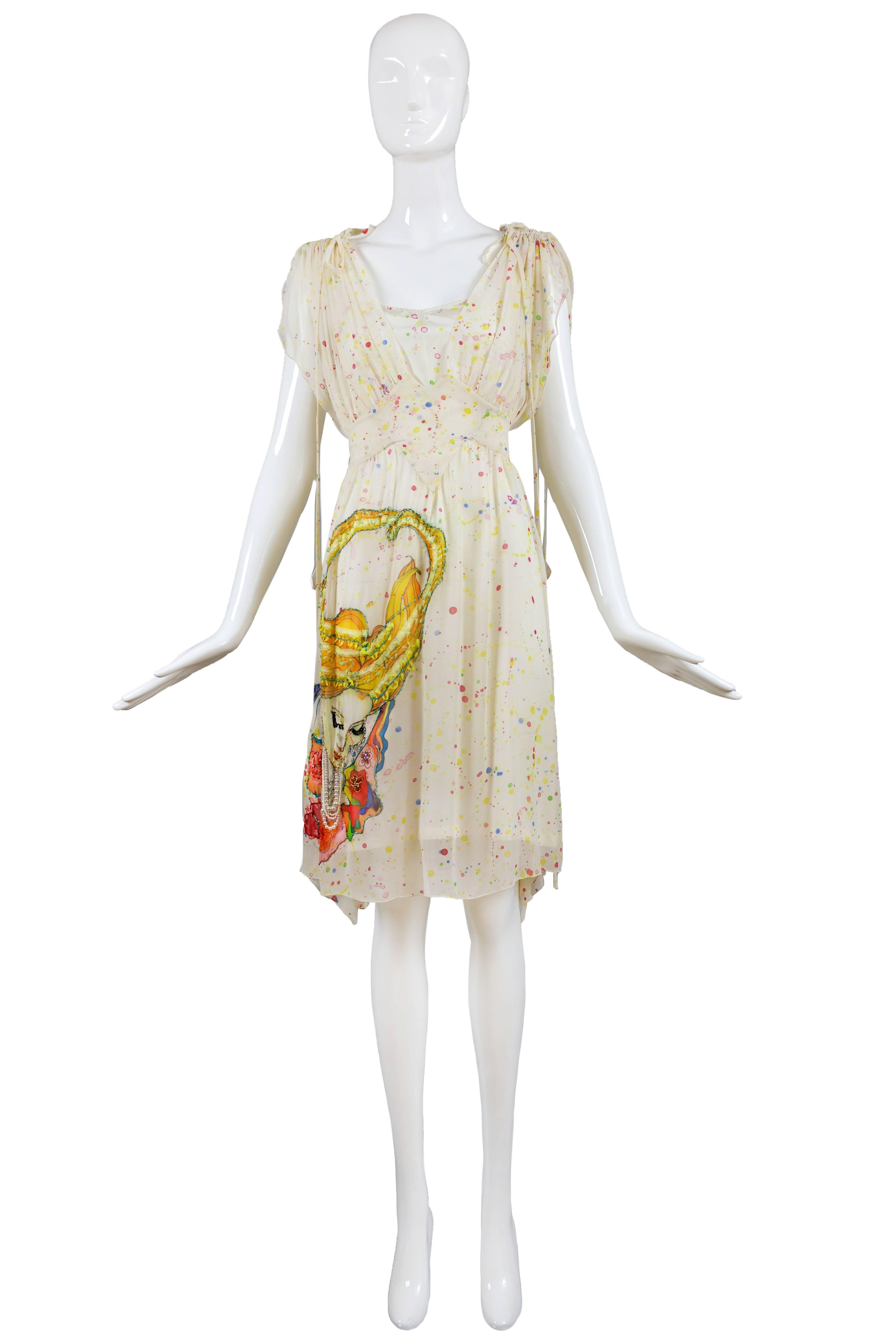 From Japanese design talent Tsumori Chisato, this limited edition, romantic 100% silk creme chiffon multi-colored polka dot print knee-length day dress with gathered shoulders and ties, deep v-neckline, inset waist yoke and matching slip. At the