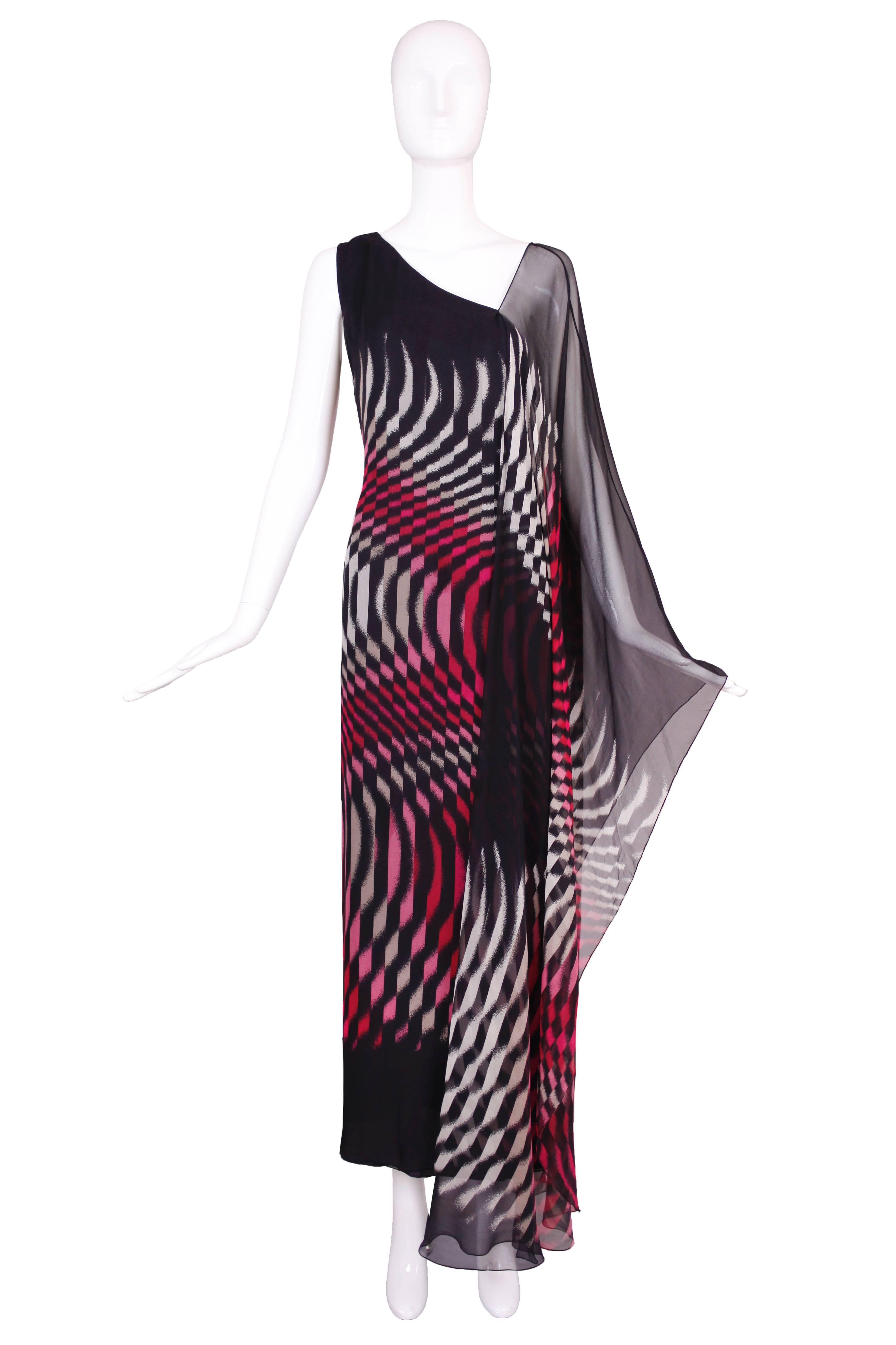 Hanae Mori double layered silk chiffon gown in a geometric pattern of pink, grey, red and black. One shoulder fabricated from a floor-length chiffon scarf that attaches to the dress via a side seam down the length of the back. Cut on the bias and