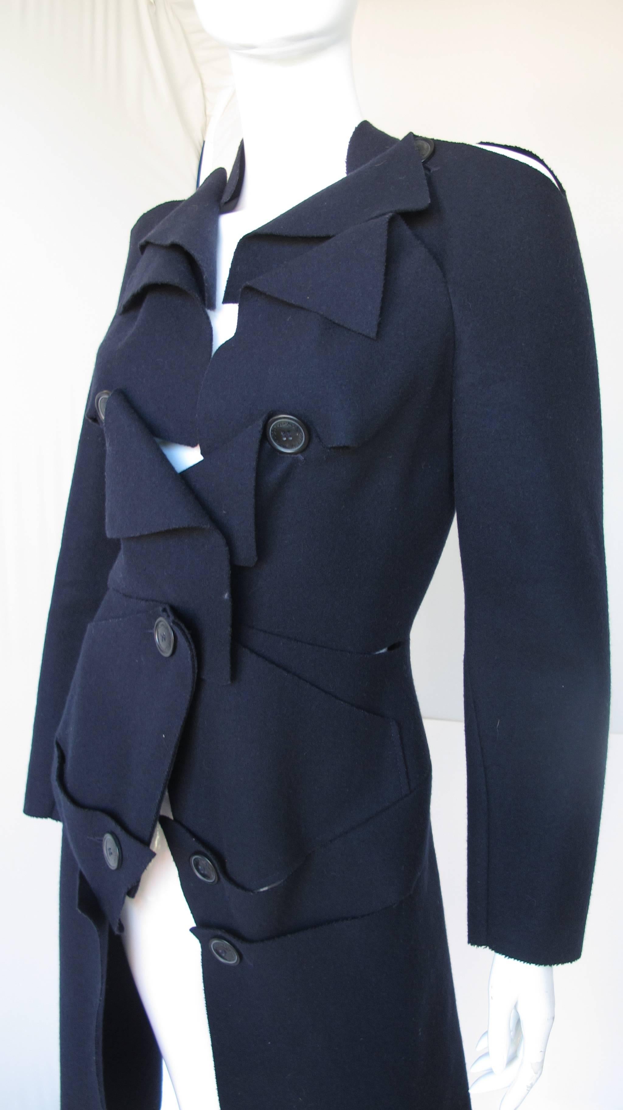 A Vivienne Westwood Anglomania navy blue wool “slashed” fitted coat with oversized buttons. Size tag 40. In excellent condition.
MEASUREMENTS:
Waist – 28