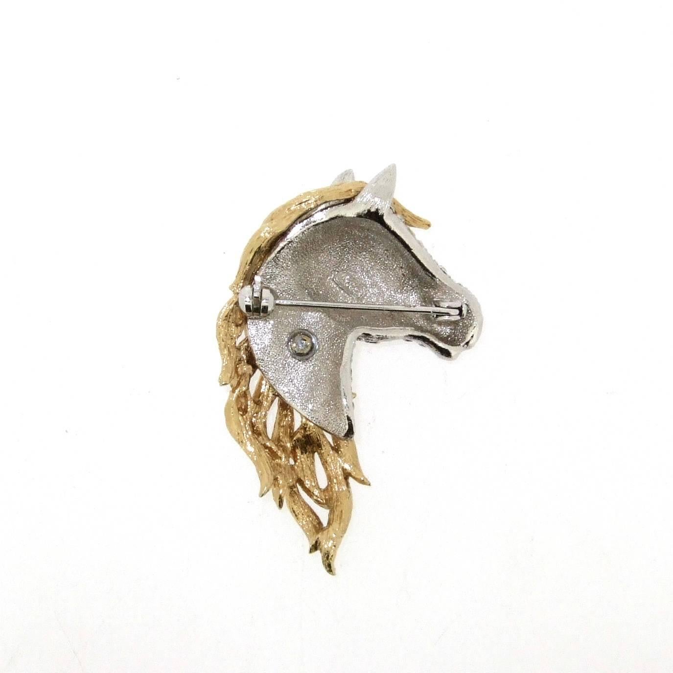 A stunning brooch of a horses head and mane by British jeweller Attwood & Sawyer in costume metal. Featuring a gold plated mane with crystal encrusted face. Stamped A&S on the back.