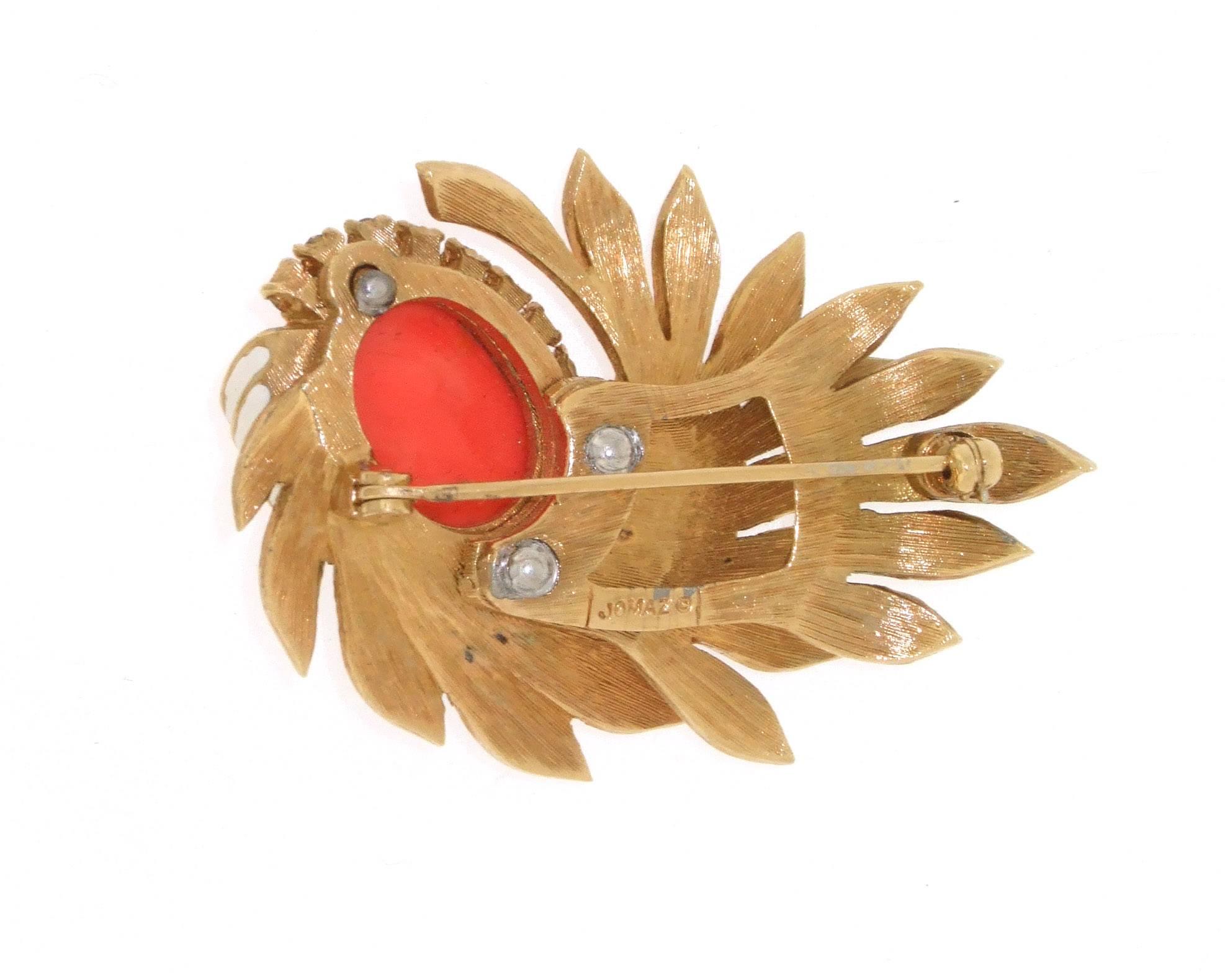 A vintage brooch by Jomaz, Joseph Mazer, with coral coloured glass set in a floral spray decorated with white enamel and clear crystals. In gold plated costume metal. The matching earrings are available in a separate listing.

It measures 5.2cm