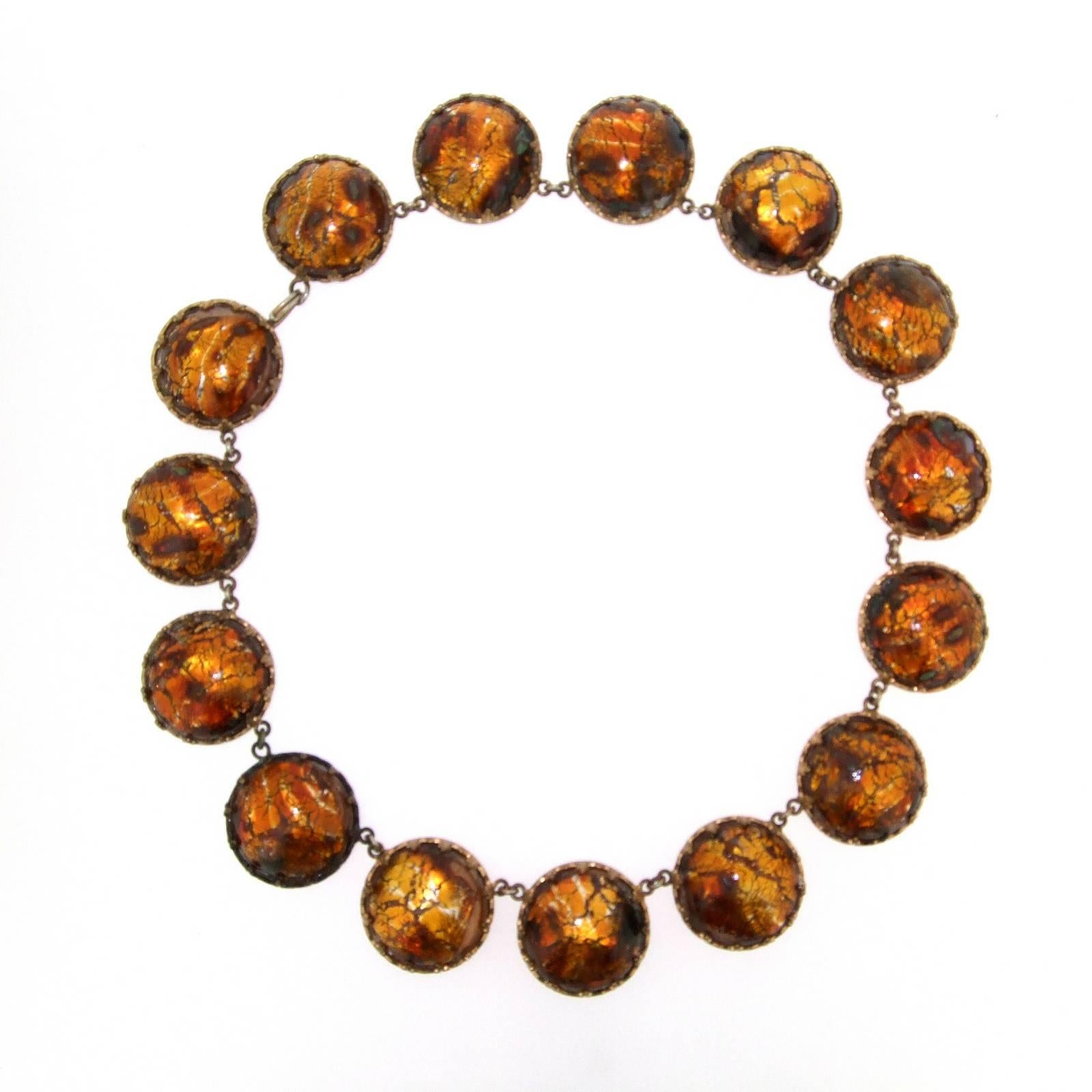 A beautiful vintage amber effect venetian foil glass necklace in great condition.

 It measures: 15 inches around the neck. each disc is 2.2cm wide.