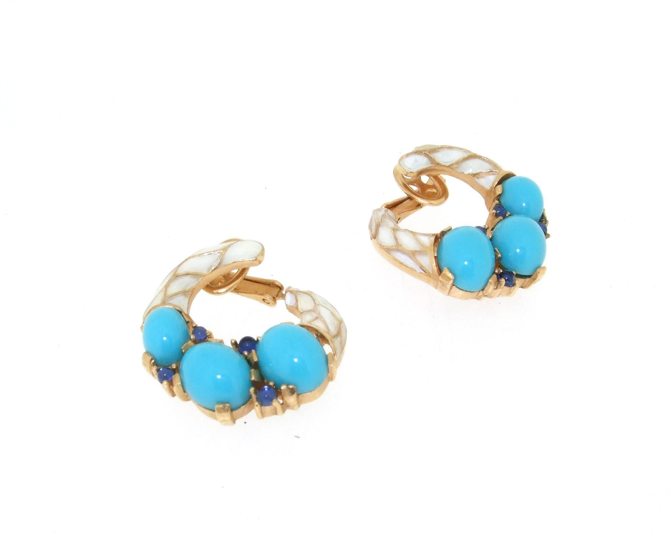 A collectable pair of clip on earrings by Trifari USA from their 1968 L'Orient collection. Set in gold plated costume metal with white enamel, turquoise and sapphire blue glass. 

They measure 2.7cm in length by 2.5cm wide, 0.7cm deep.