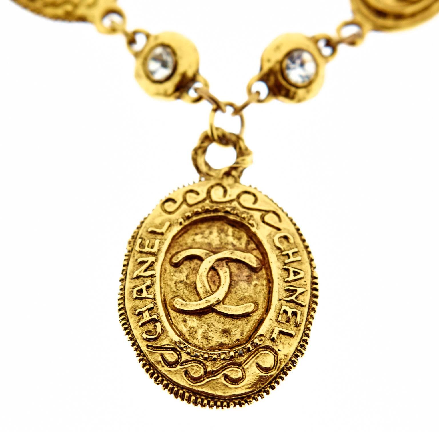 A vintage Chanel necklace from the 1970s with 9 gold plated double sided discs with the CC logo including a drop pendant. The necklace is 18 inches long plus a 1.5 inch/ 4.2cm drop pendant which is 2.7cm wide. The medium discs are 1.9cm wide. The