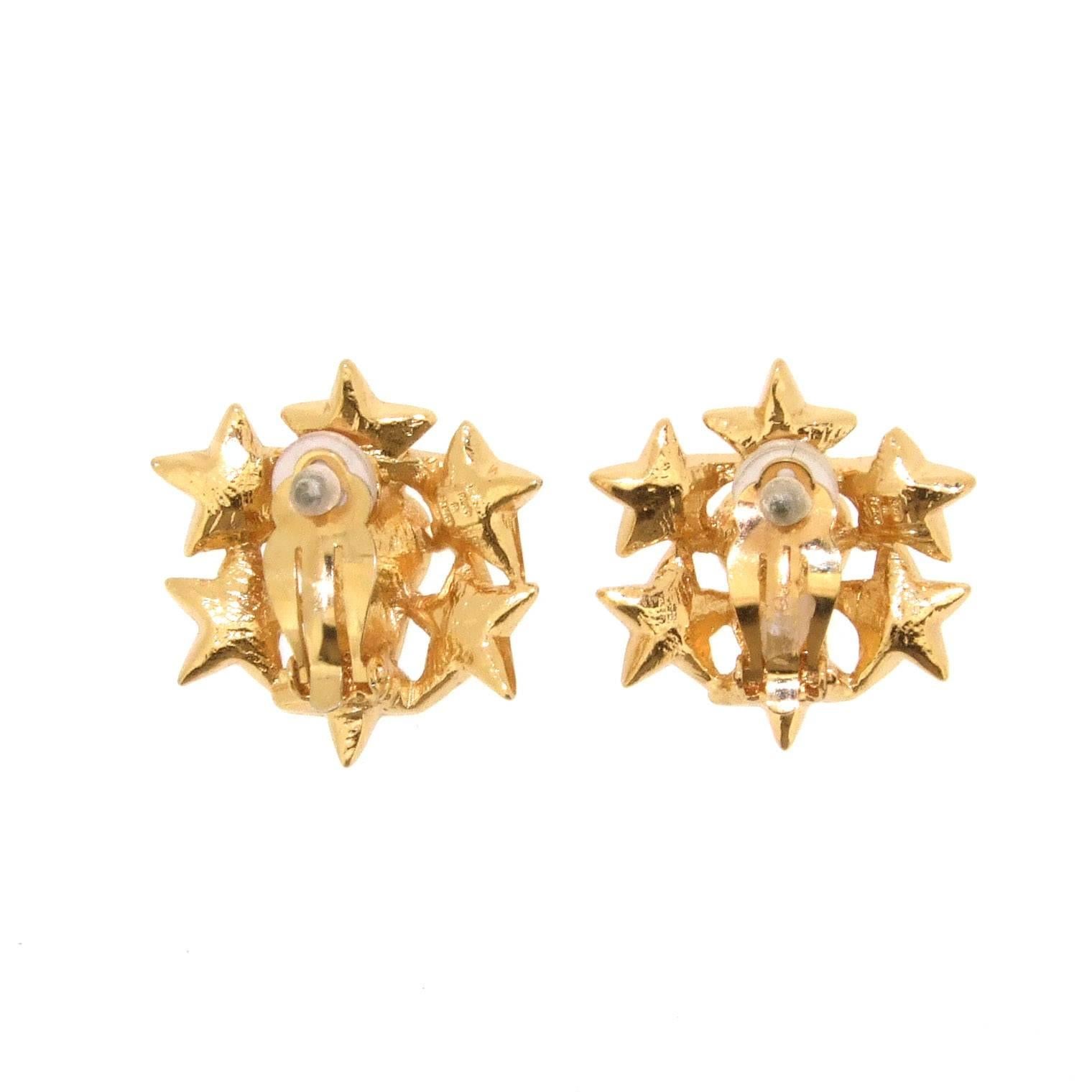 A pair of fabulous clip on earrings by Yves Saint Laurent set with star and heart crystals in gold plated metal.

They measure 3cm wide by 1.3cm deep including the clip. 