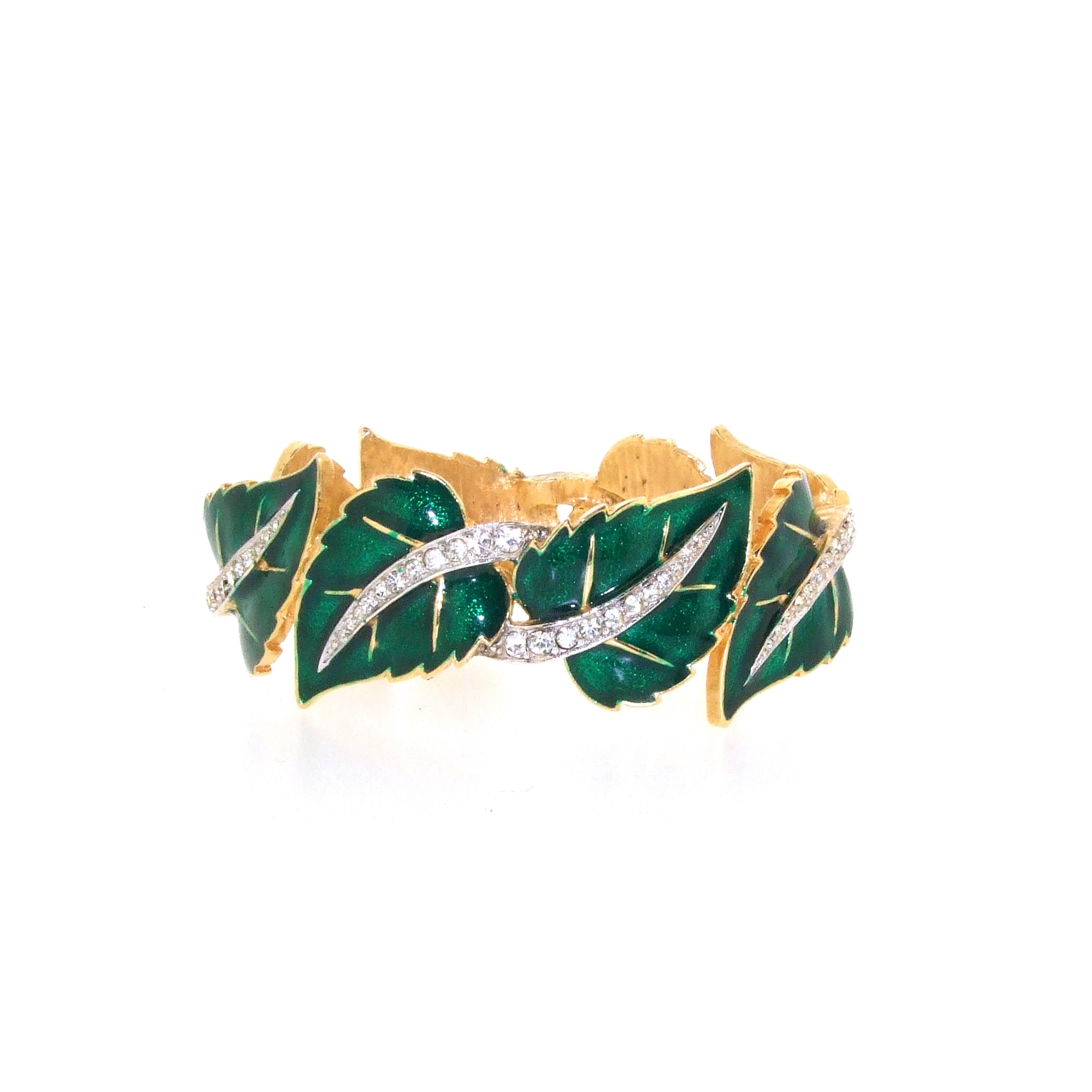 A beautiful clamper bracelet by Jomaz, Joseph Mazer, from the 1950s.
Pretty green enamelled ivy leaves decorated with crystal.

 It measures: 5.9cm wide, 2.1cm high, 7 inches around the wrist.