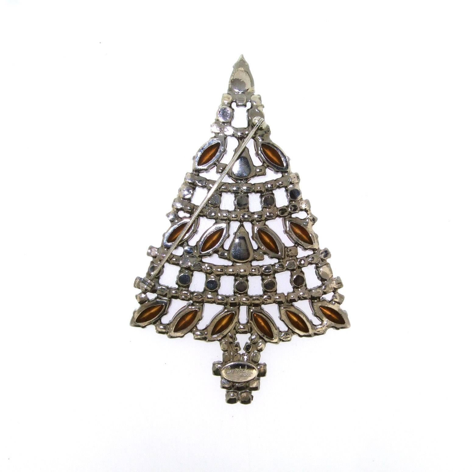 A large Christmas Tree brooch by Cristobal London, in antiqued silver tone metal set with pink, green and red crystals.

It measures 10cm high by 6.5cm wide, 0.5cm deep.