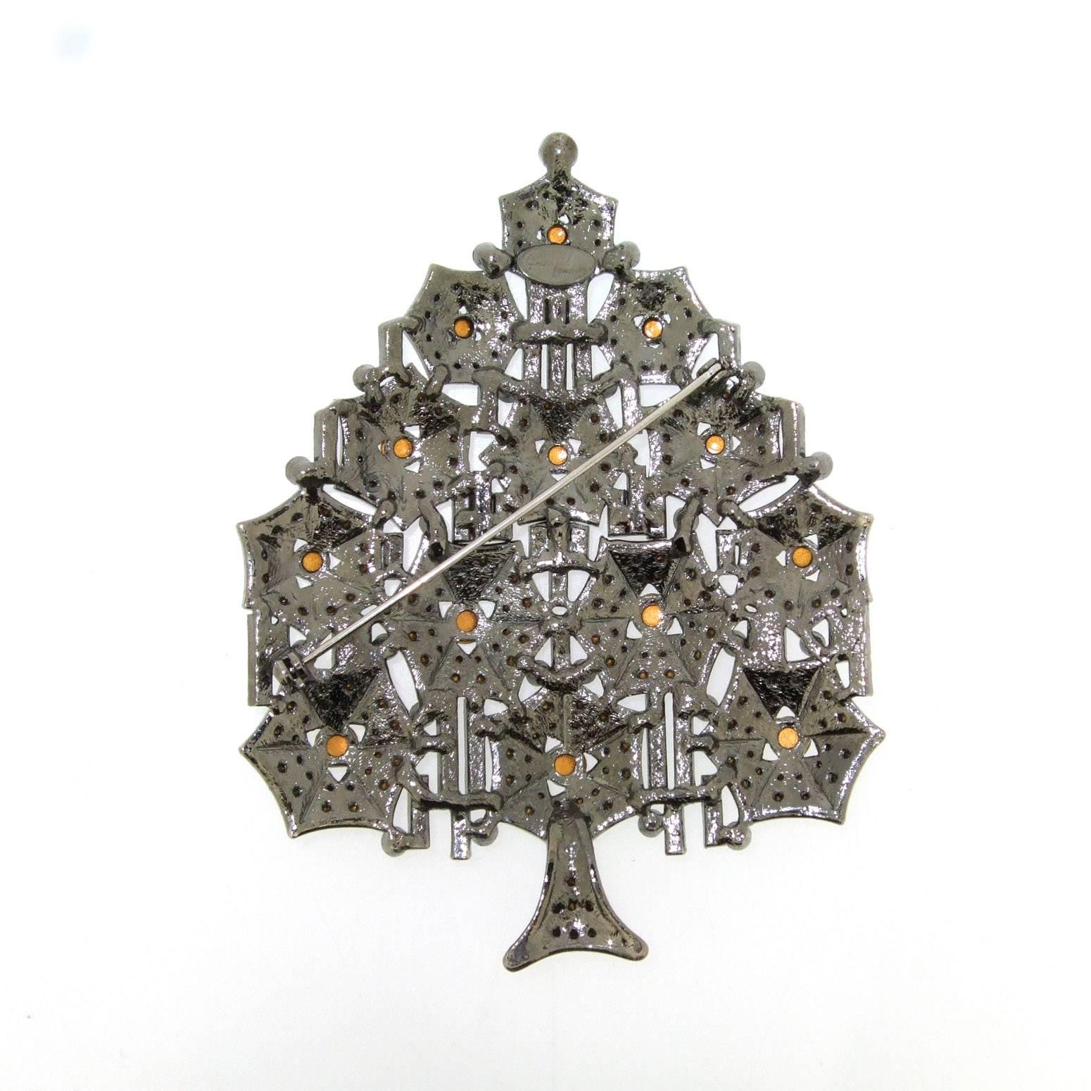 A large oversized Christmas tree brooch in Art Deco style by Cristobal London with clear crystals set in darkened silver tone costume metal. 

 It measures 10.6cm high by 8.3cm at the widest point.