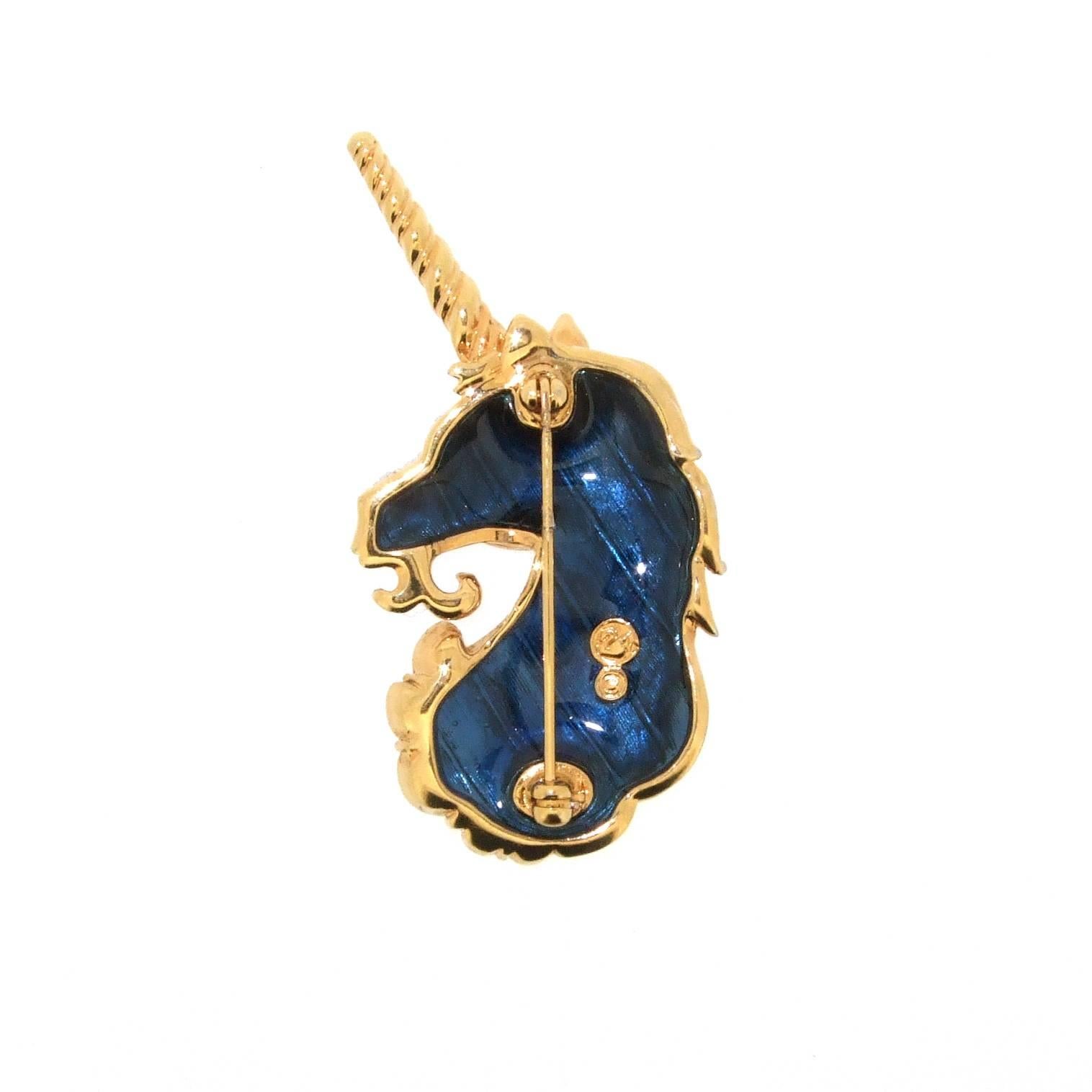 A stunning unicorn brooch by Swarovski. Clear sparkling swarovski stones set in gold plated metal and finished with blue enamel on the reverse.

It measures 6.1cm high by 3cm wide by 0.8cm deep.

It can be viewed in person at Hirst Antiques London,