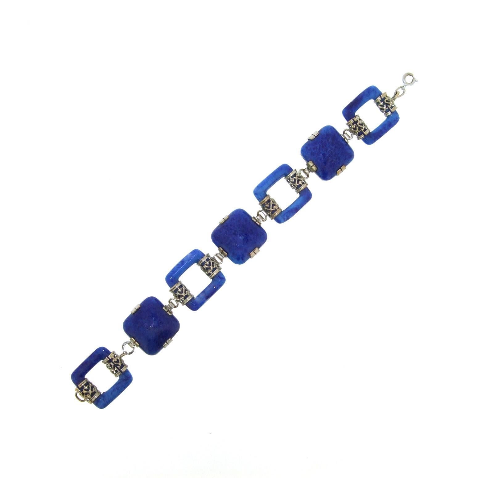 A stunning lapis effect blue Czechoslovakian glass Art Deco bracelet. This glass is sometimes known as 'swiss lapis' with its lapis emulation. 

The squares measure 2cm wide by 1.8cm, the bracelet measures 7 1/2 inches/ 19.2cm long, by 1.8cm wide,