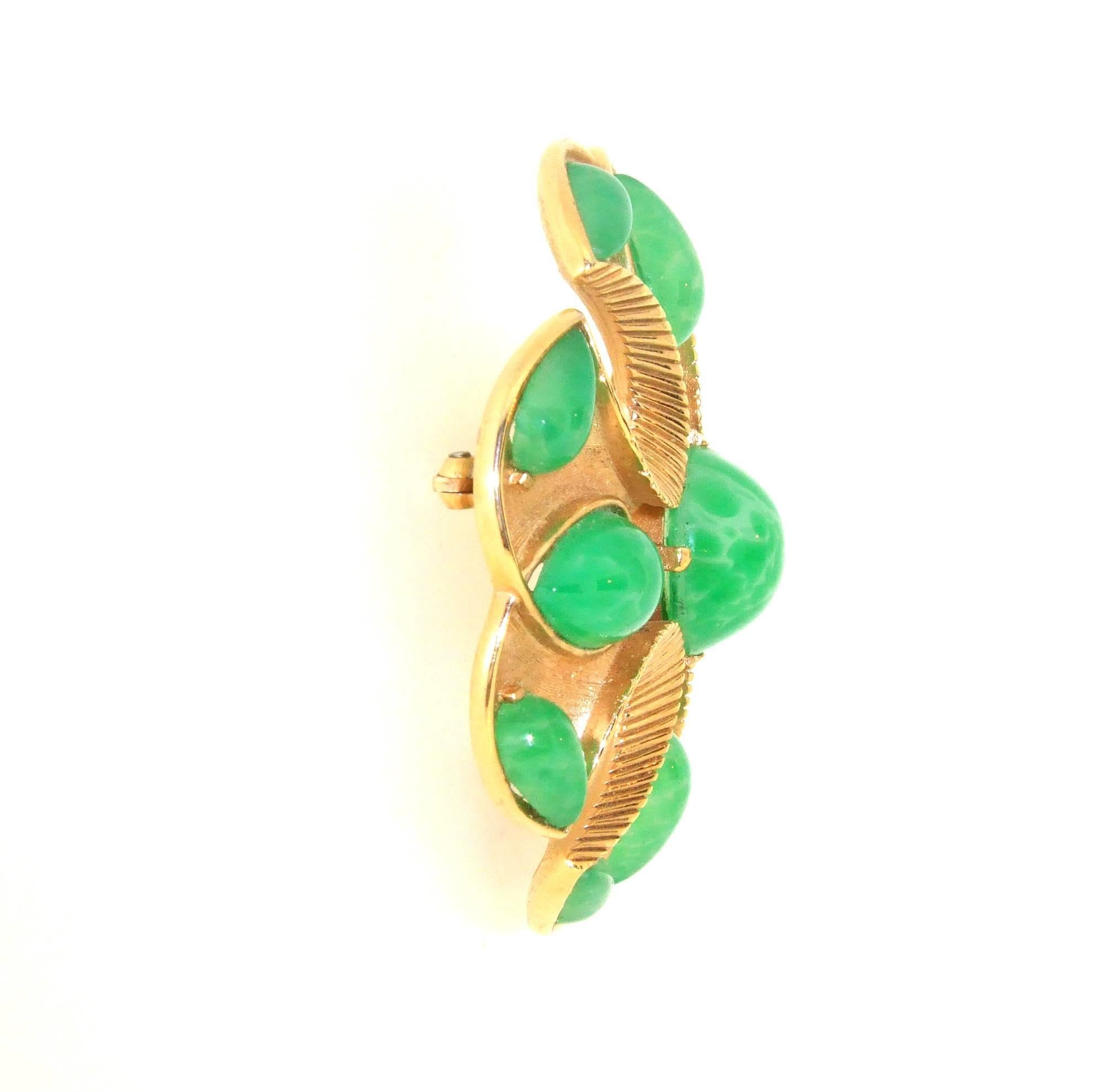 A vintage brooch in a Maltese shaped cross by Trifari from the Jewels of India Collection 1965 with jade effect vintage glass.

Trifari was founded in the USA by Italian Gustavo Trifari in 1910. Chief designer of Trifari between 1930 and 1968 was