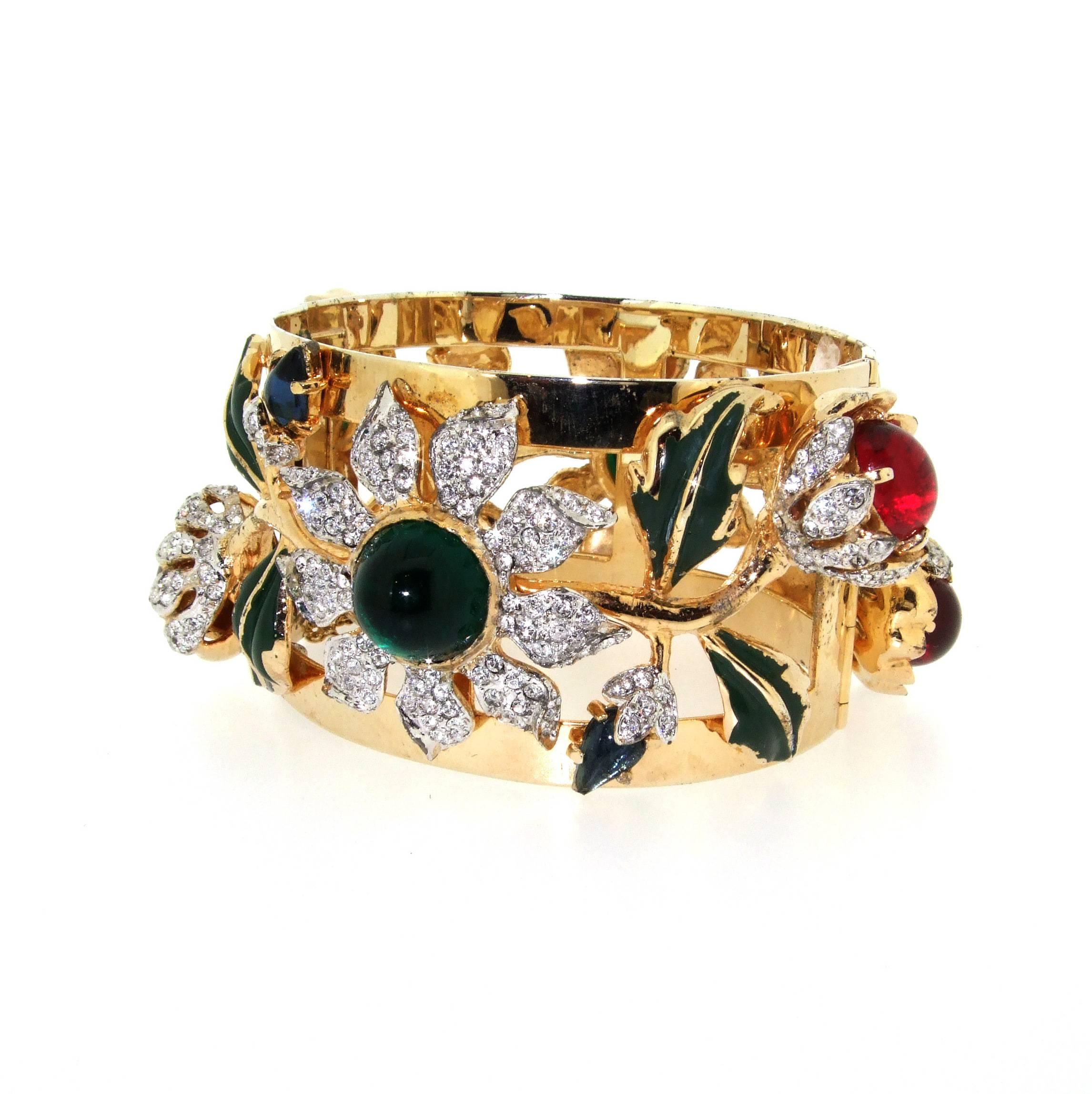 A rare Vintage Cuff Bracelet by Vendome, gold plated and set with glass and crystals, with green handpainted leaves. It is considered to be a costume version of the gold, diamond and emerald bracelet given to Paulette Rowe by her husband Charlie