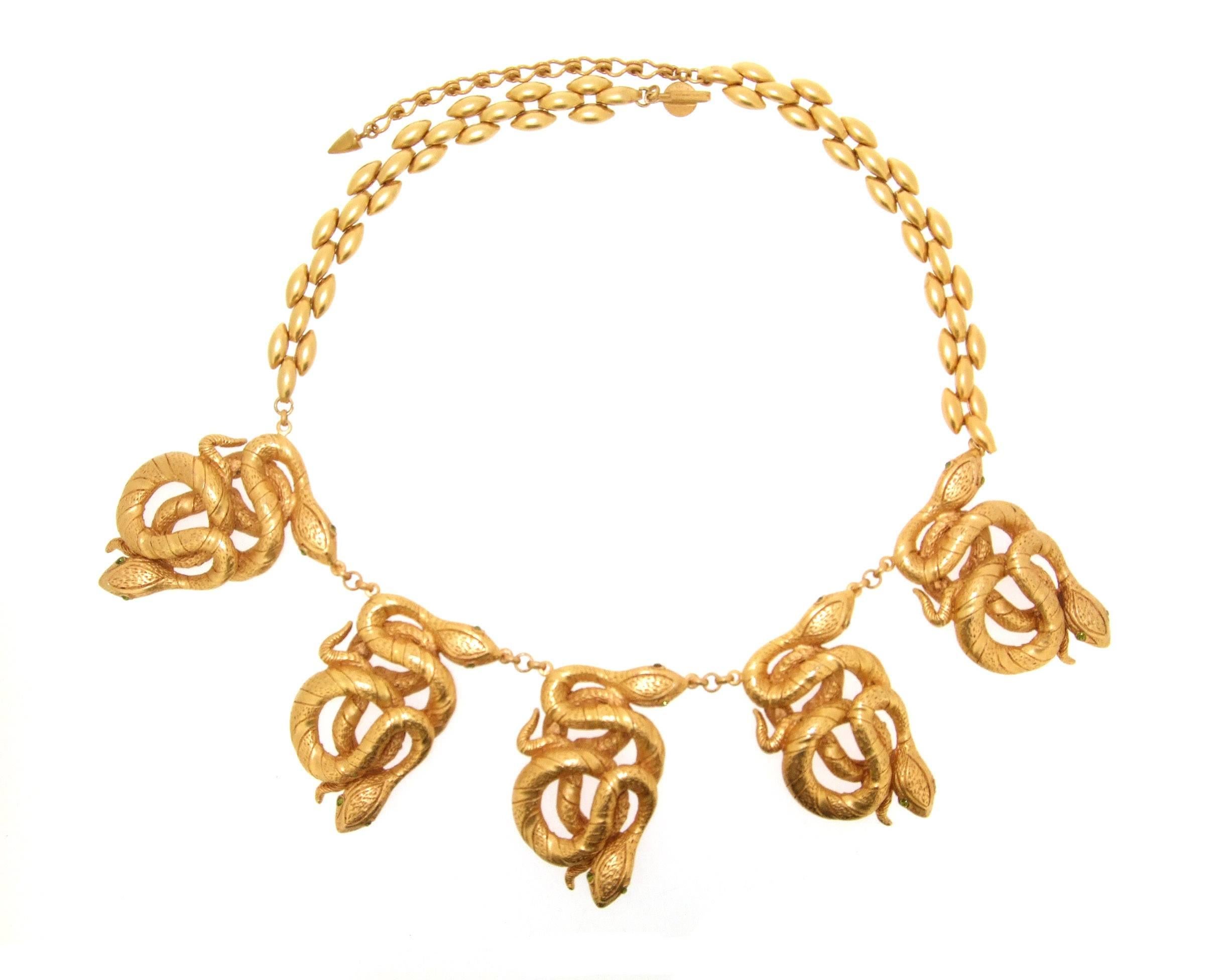 A statement necklace by Askew London featuring serpent pendants in gold plated metal set with crystal eyes.

It can be worn between 16-18 inches in length as it has an adjustable catch and chain. Each snake pendant is 3cm by 5cm wide.