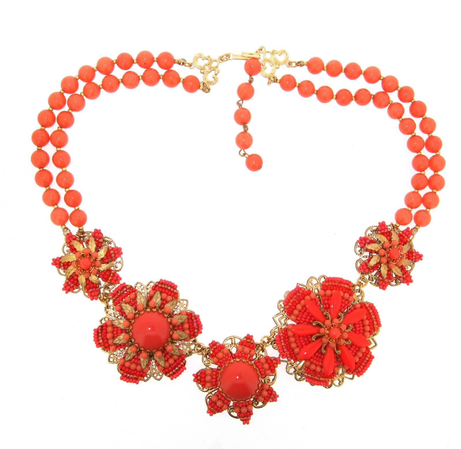 A beautiful vintage statement necklace by Stanley Hagler NYC with a floral intricate beadwork design in vintage coral glass. It can be worn between 20 and 22 inches in length with the adjustable chain and catch. The biggest section is 5cm