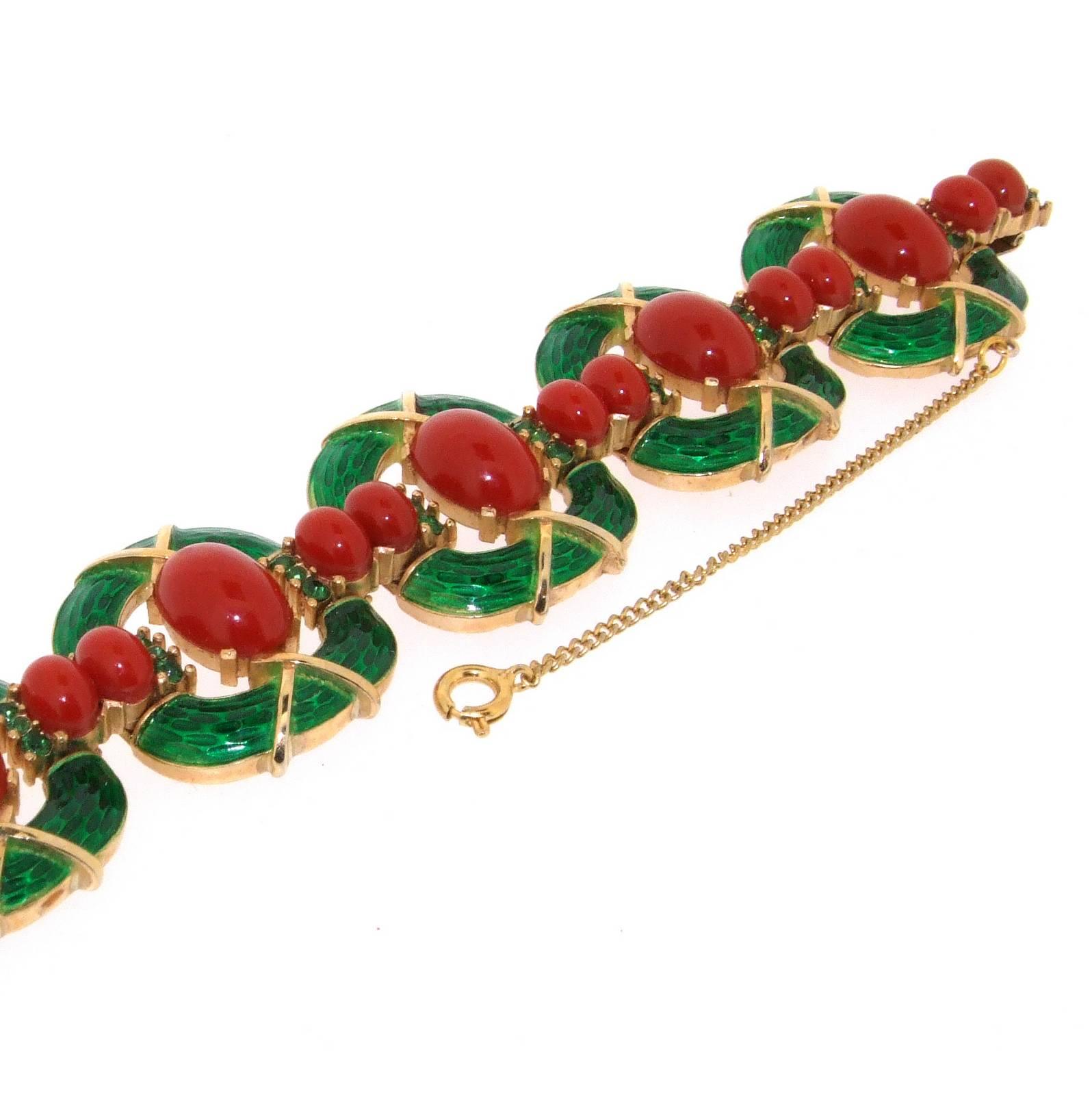 A rare vintage bracelet by Trifari from the L'Orient colection 1968. In gold tone metal with green enamel and carnelian coloured glass cabuchons.

Trifari was founded in the USA by Italian Gustavo Trifari in 1910. Chief designer of Trifari between