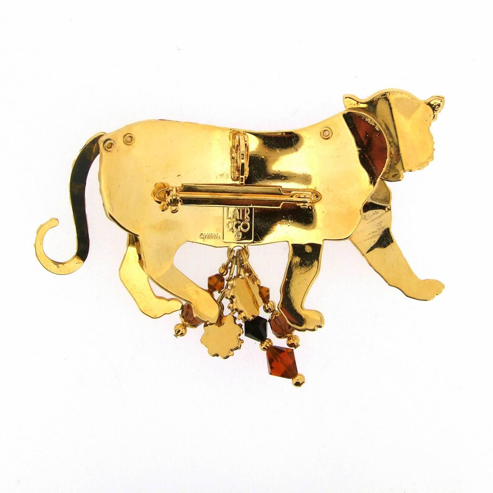 A fabulous large tiger brooch by Lunch At The Ritz featuring moving limbs. The Tails and front yellow enameled legs move back and forth.

Lunch At The Ritz was launched in 1982 and creates the most fun, whimsical and enchanting jewellery,