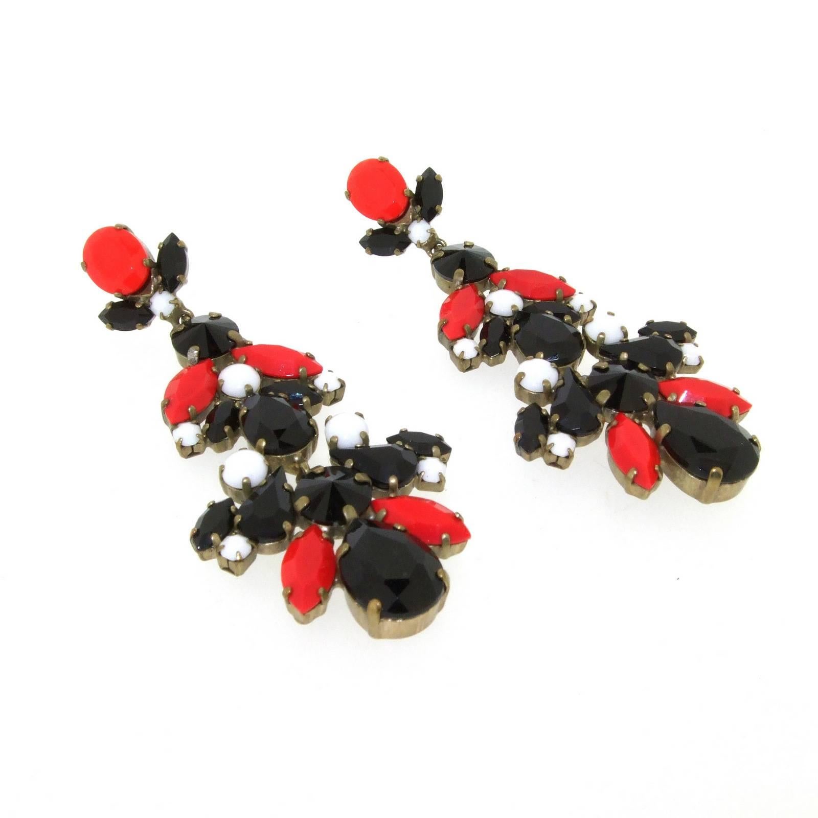 A pair of statement earrings by Greek designer Frangos. Set with black, red and milk white crystal. Each section hangs freely of each other.

They are 4cm at the widest point.