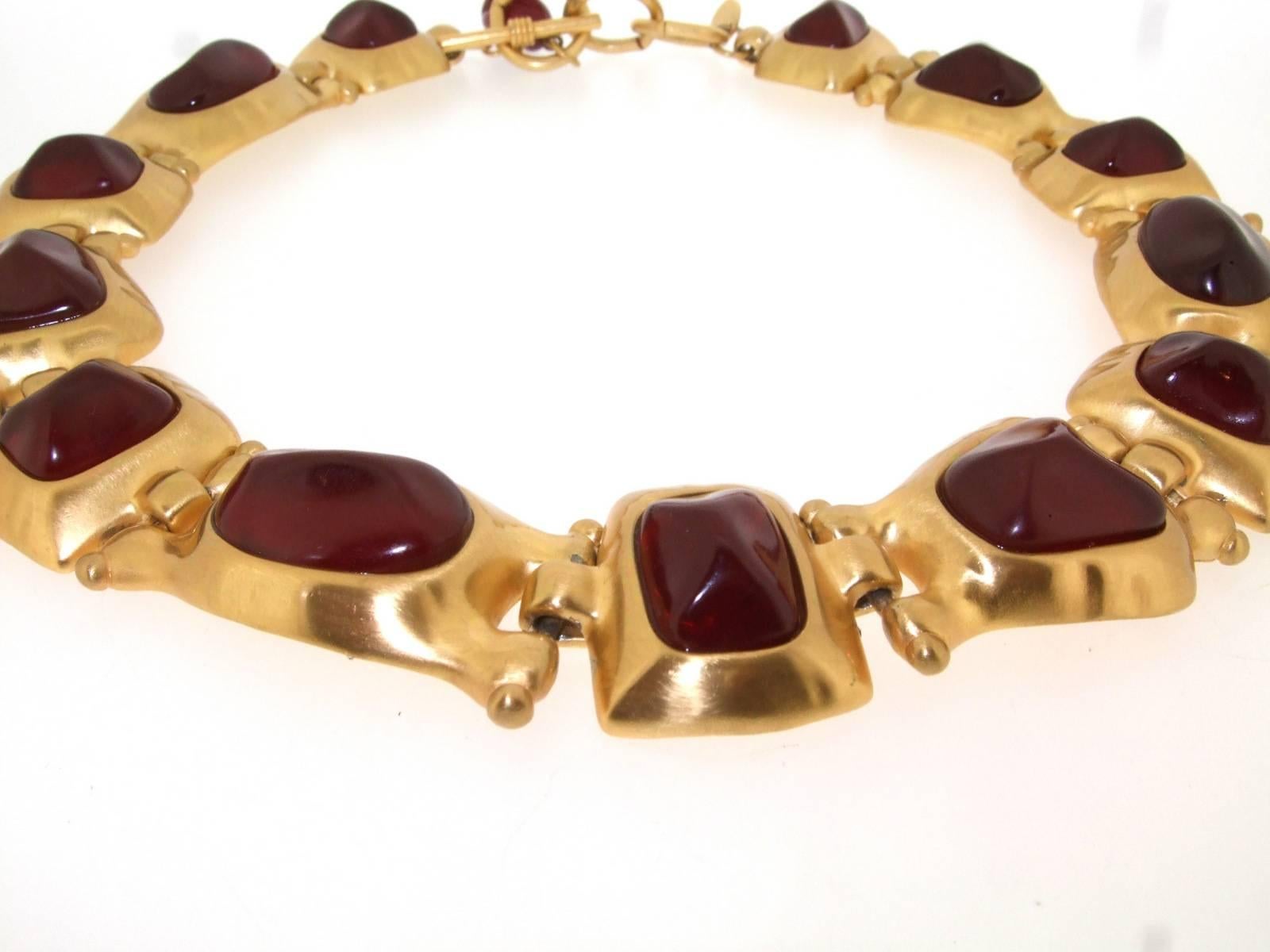 A vintage statement necklace by Anne Klein in gold plated metal set with acrylic ruby effect stones. 