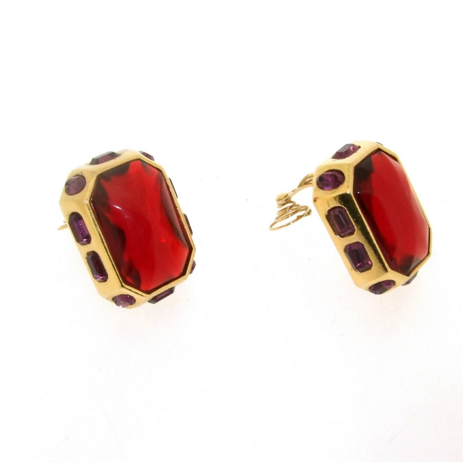 A pair of vintage clip on earrings by Yves Saint Laurent set with red and purple crystal.