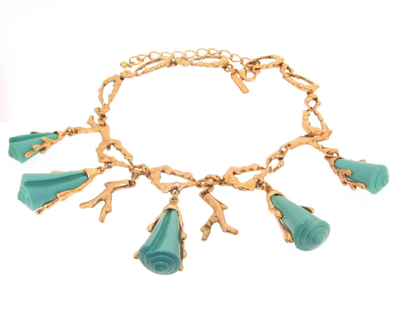 A statement necklace by Oscar De La Renta featuring turquoise acrylic seashells in gold plated coral effect branches. 
It measures 18 -22 inches in length with an adjustable length of chain with clasp. The turquoise seashell drops are 2 inches/ 5cm