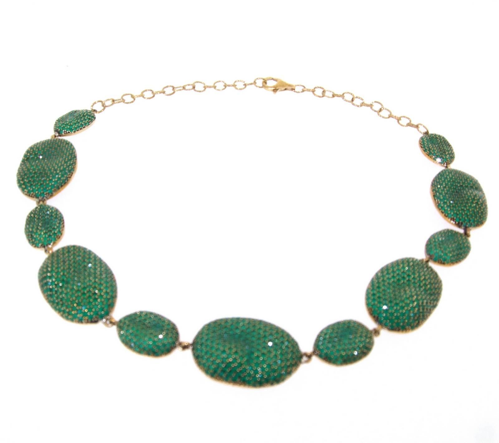 A stunning necklace by JCM London. Each misty emerald effect cubic zirconia encrusted pebble has a natural undulating uneven formation to give it the feel of the shape of a natural pebble. 

The smaller ovals measure 2cm long by 1.3cm wide.  The
