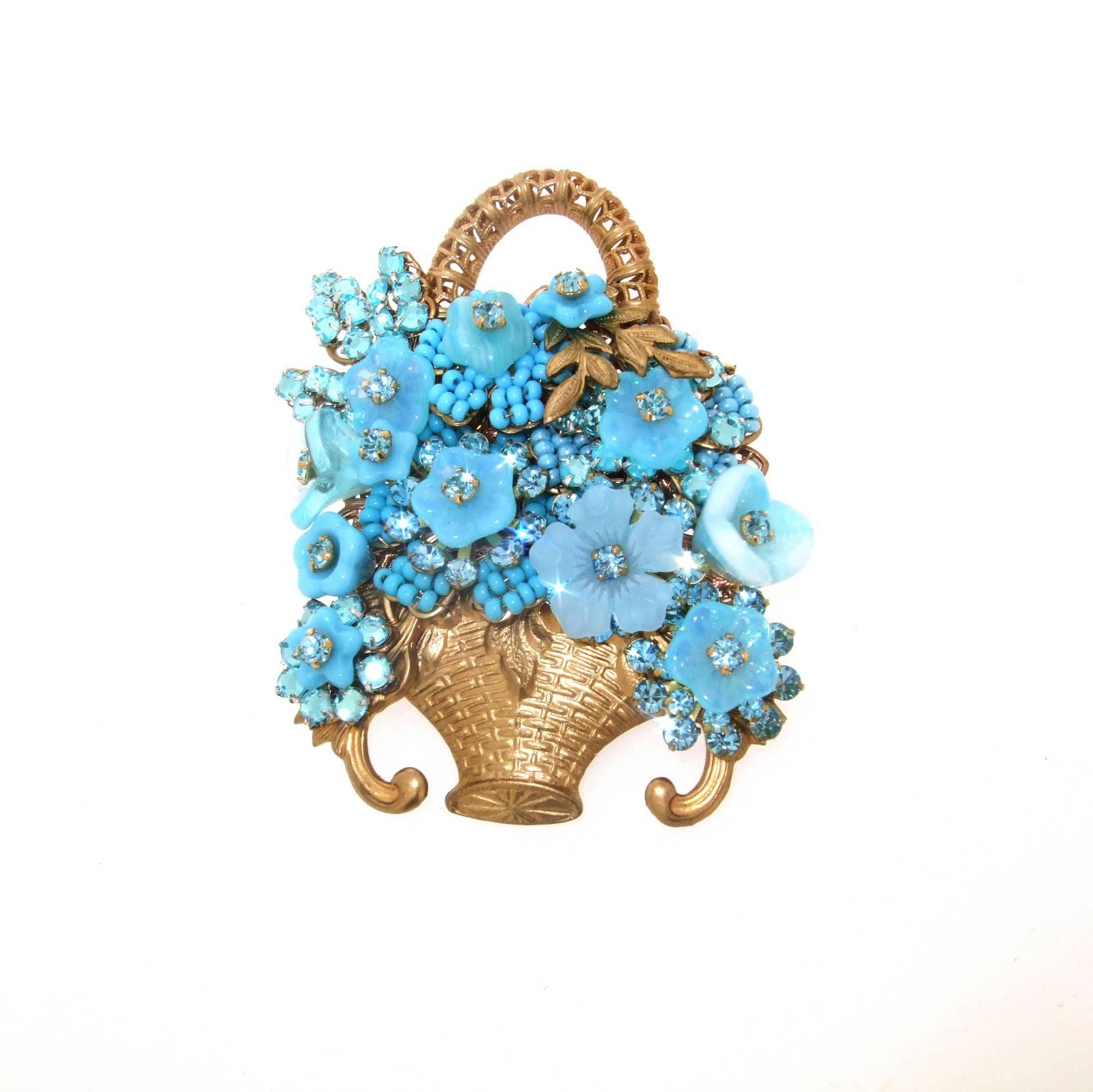 A beautiful vintage brooch by Stanley Hagler of a turquoise blue basket of flowers with vintage glass and crystals.

It measures 5cm wide by 6.4cm high.