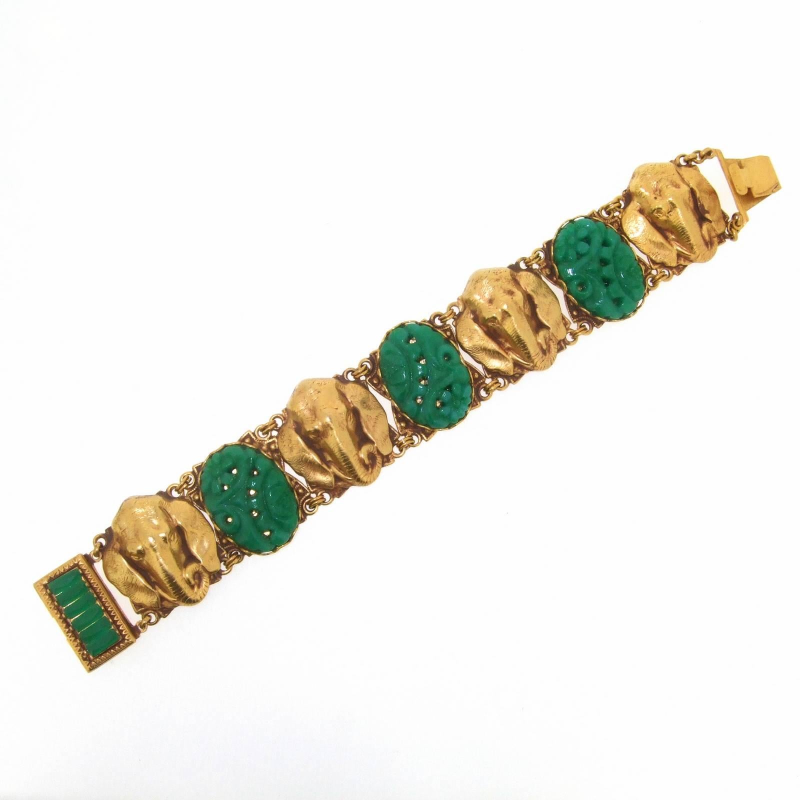 A new gold plated bracelet by Askew London set with gold elephant faces and jade effect vintage glass. 

It measures: 7 1/2 inches long/ 18.2cm by 2.5cm deep. Stamped Askew London inside.