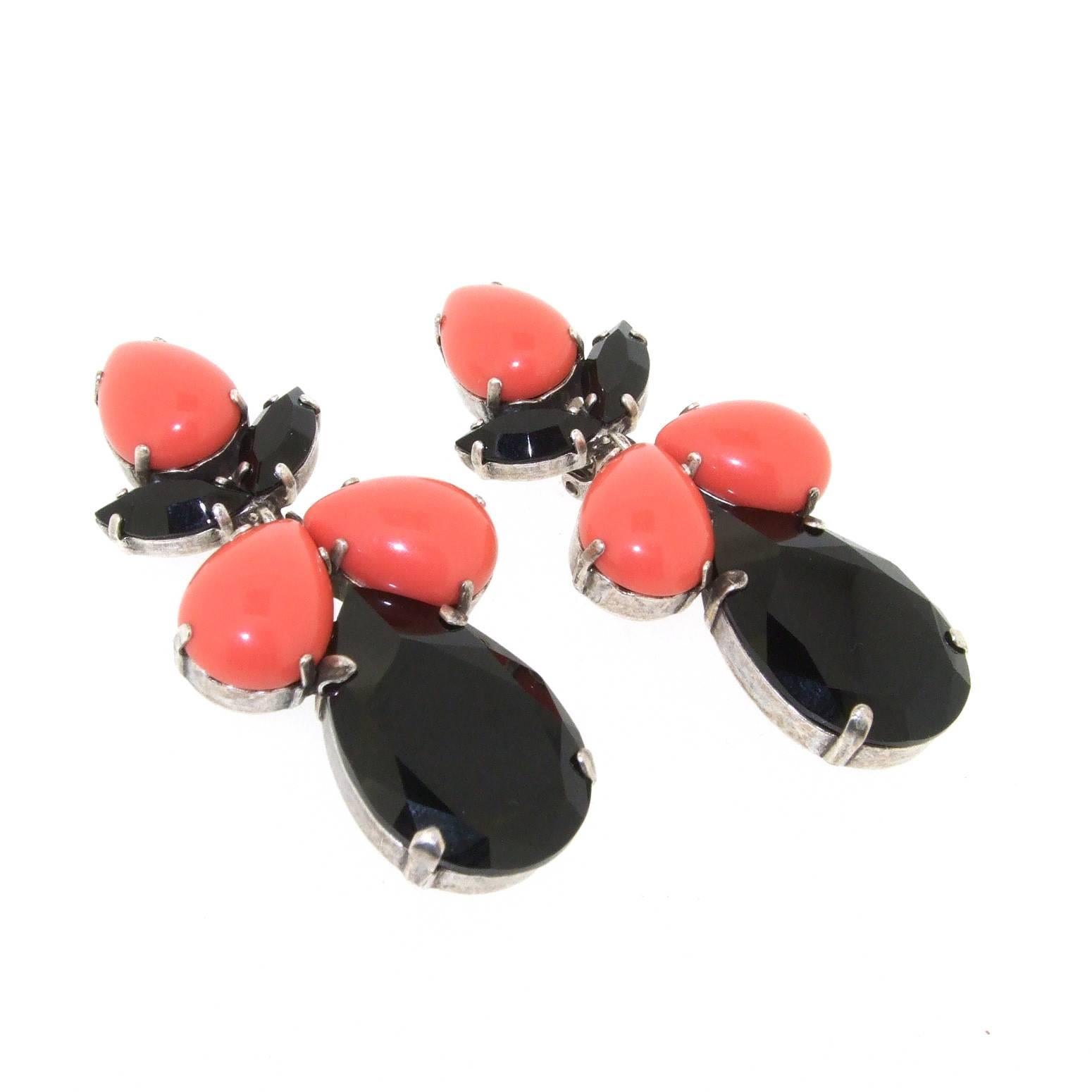 A pair of new chandelier clip on earrings by Frangos in black crystal and coral vintage glass, set in silver tone costume metal. 

 They measure 7cm drop by 3.2cm wide.