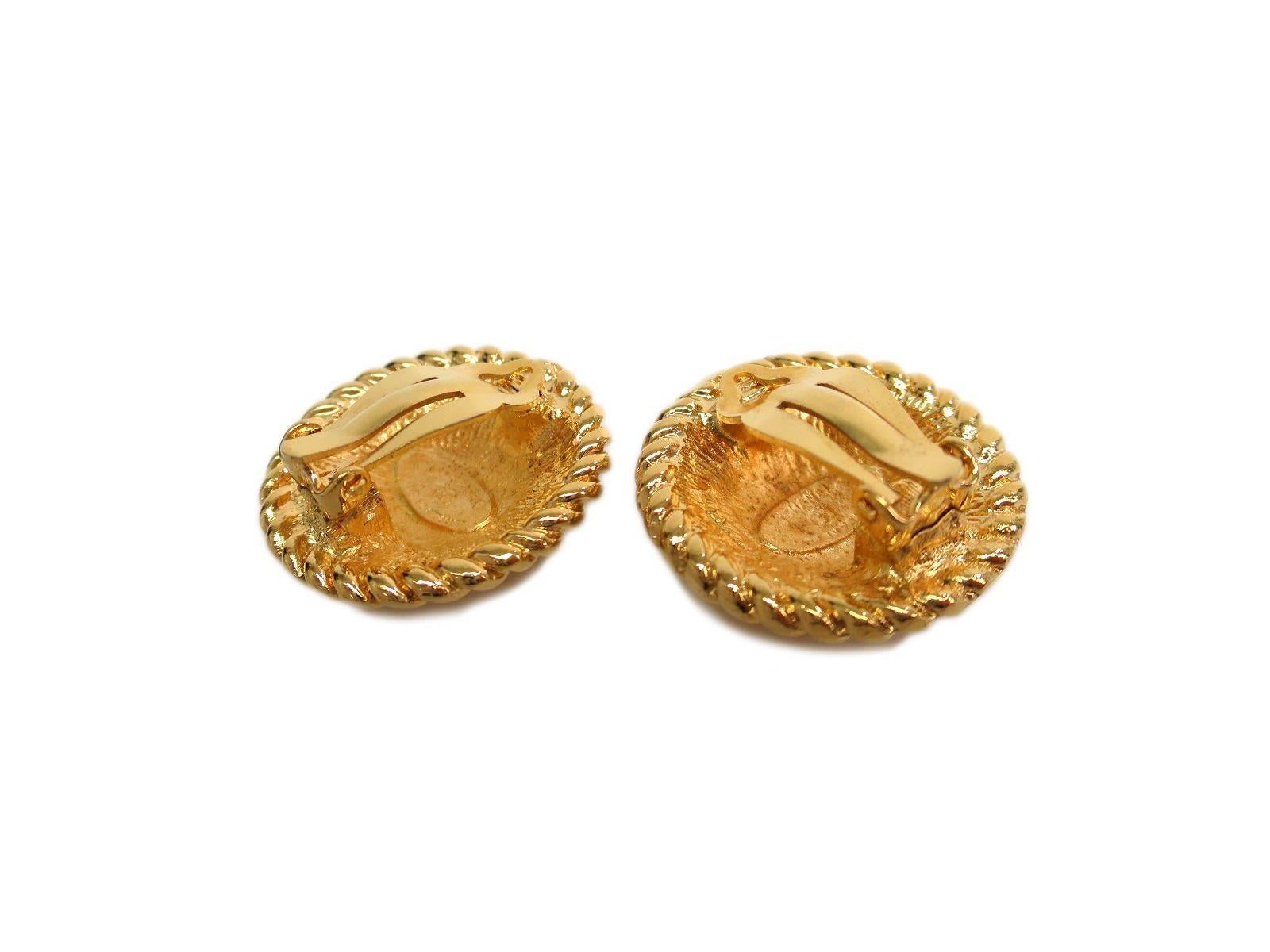 Are you royalty because you sure look it with these rich Chanel gold button earrings dangling from your pretty little ears.  Shiny and bold, they're a must-have for your Coco collection.

Metal
Gold plated
Clip on closure
Made in France
Measures
