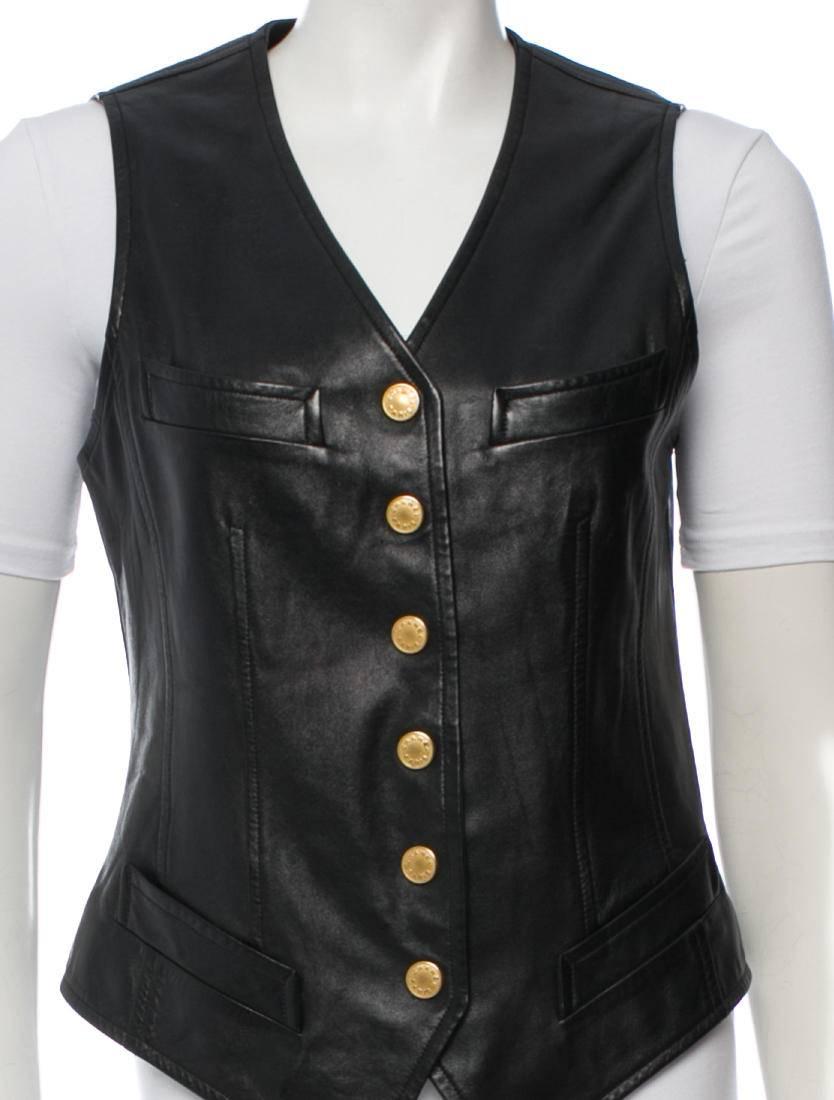CURATOR'S NOTES

Hey, biker babe!  Edgy motorcycle black Chanel vintage leather vest featuring  four pockets and gold-tone button closures at front.

Style tip: Rock it atop your favorite blouse or sport it as outer wear atop your go-to cashmere