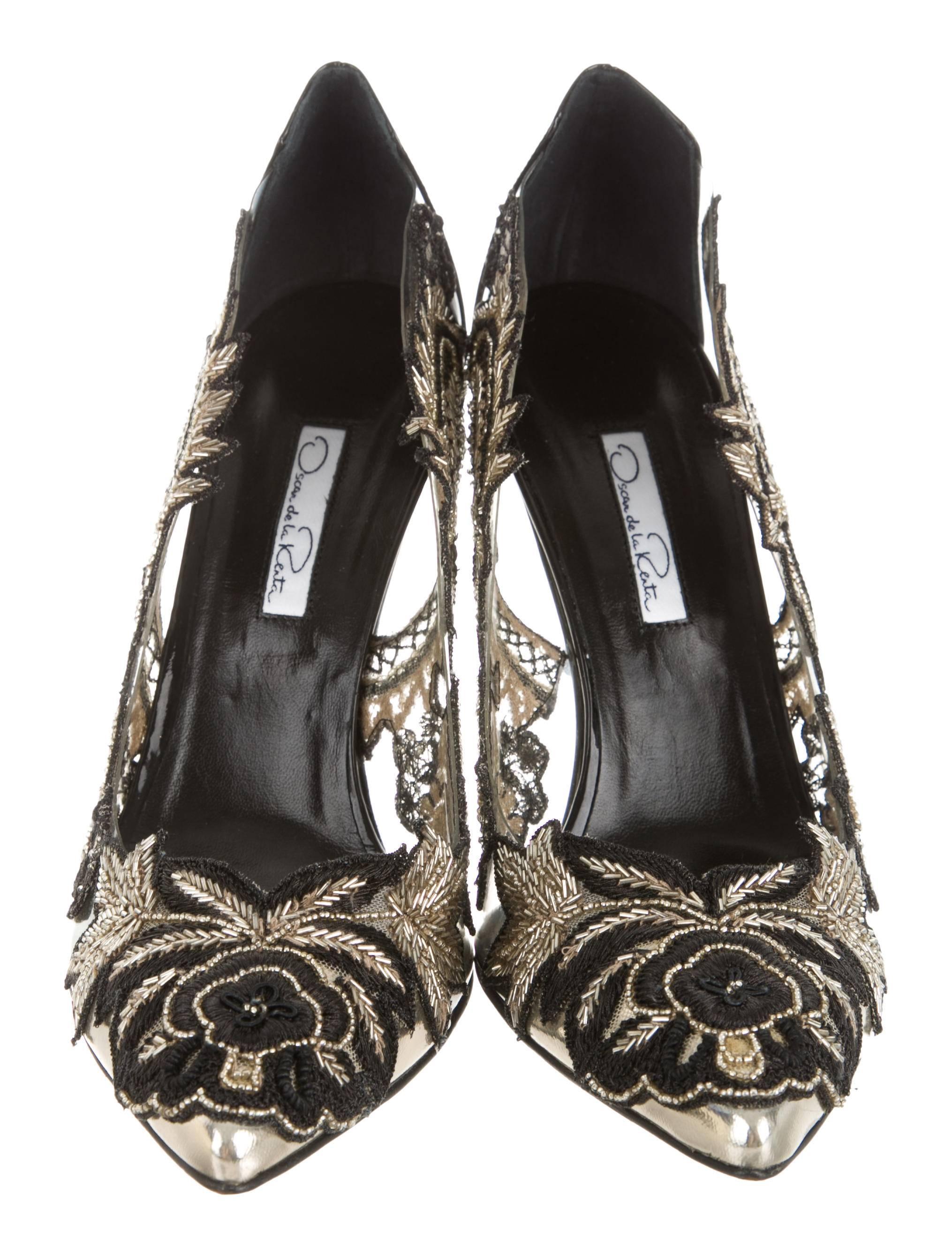 CURATOR'S NOTES

Black and gold metallic patent leather Oscar de la Renta pumps with pointed toes, PVC accents at sides featuring beaded embroidery appliqués and resin heels. Includes original Oscar de la Renta box and dust bag.

Size IT 7.5