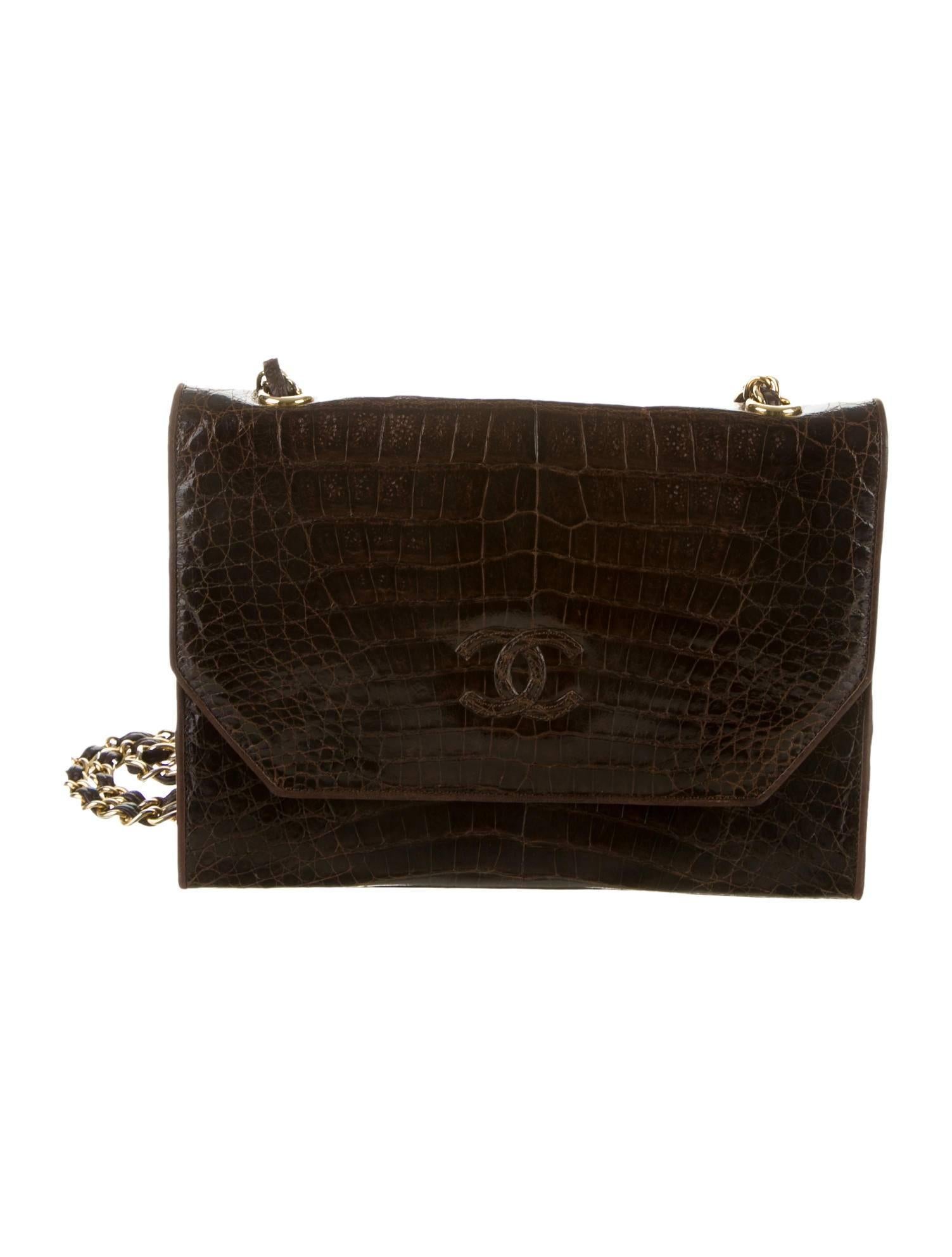 CURATOR'S NOTES

Hot CoCo anyone? Stunning rich chocolate brown crocodile Chanel shoulder bag featuring gold tone hardware, chain-link and leather shoulder strap and leather lining.  A rare find in this condition.  A chic, wearable