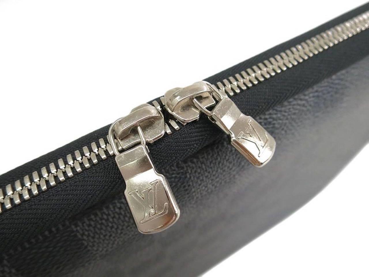 CURATOR'S NOTES

Damier canvas
Silver hardware
Zipper closure
Made in France
Date code VI2099
Measures 13.8