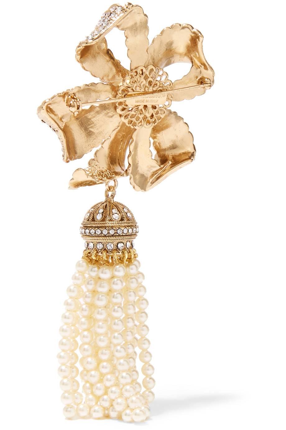 CURATOR'S NOTES

Brass
Gold tone
Swarovski crystal
Faux pearl
Pin closure 
Made in Italy
Measures 2.5