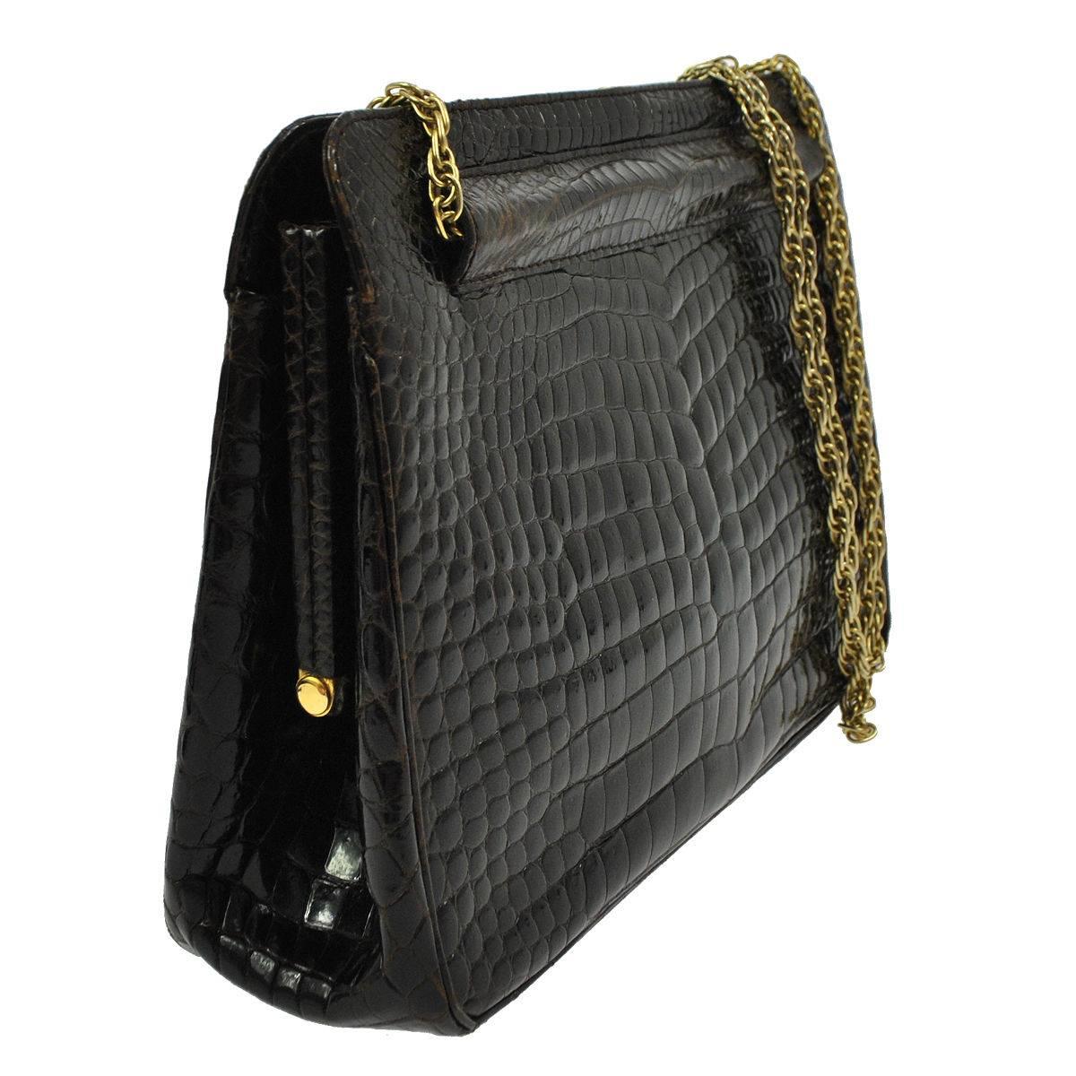 Chanel Rare Vintage Dark Brown Croc Leather Gold Evening Kisslock Top Handle Bag

Crocodile
Gold tone hardware
Kisslock closure
Leather lining
Made in France
Shoulder strap drop 12"
Measures 9.5" W x 6.5" H x 2.5" D 
Includes