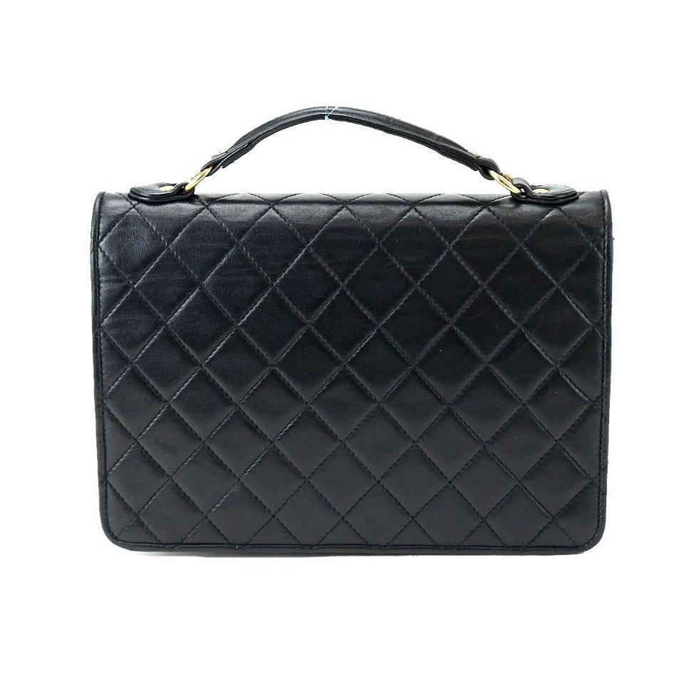 Chanel Vintage Black Lambskin Dual Turnlock Top Handle Satchel Shoulder Flap Bag

Lambskin
Gold tone hardware
Dual turnlock closure
Made in France
Handle drop 3"
Measures 9" W x 6" H x 2" D 
Shoulder strap drop 15"