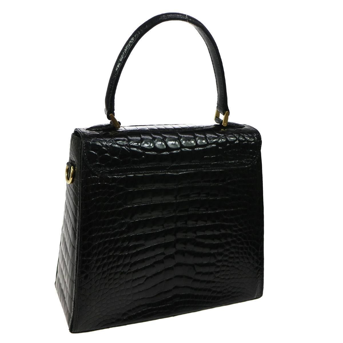 CURATOR'S NOTES

Salvatore Ferragamo Black Rare Kelly Evening Top Handle Satchel Bag  

Crocodile
Gold tone hardware
Turnlock closure
Leather lining 
Made in Italy
Handle drop 4.5"
Measures 10" W x 9.5" H x 4" D