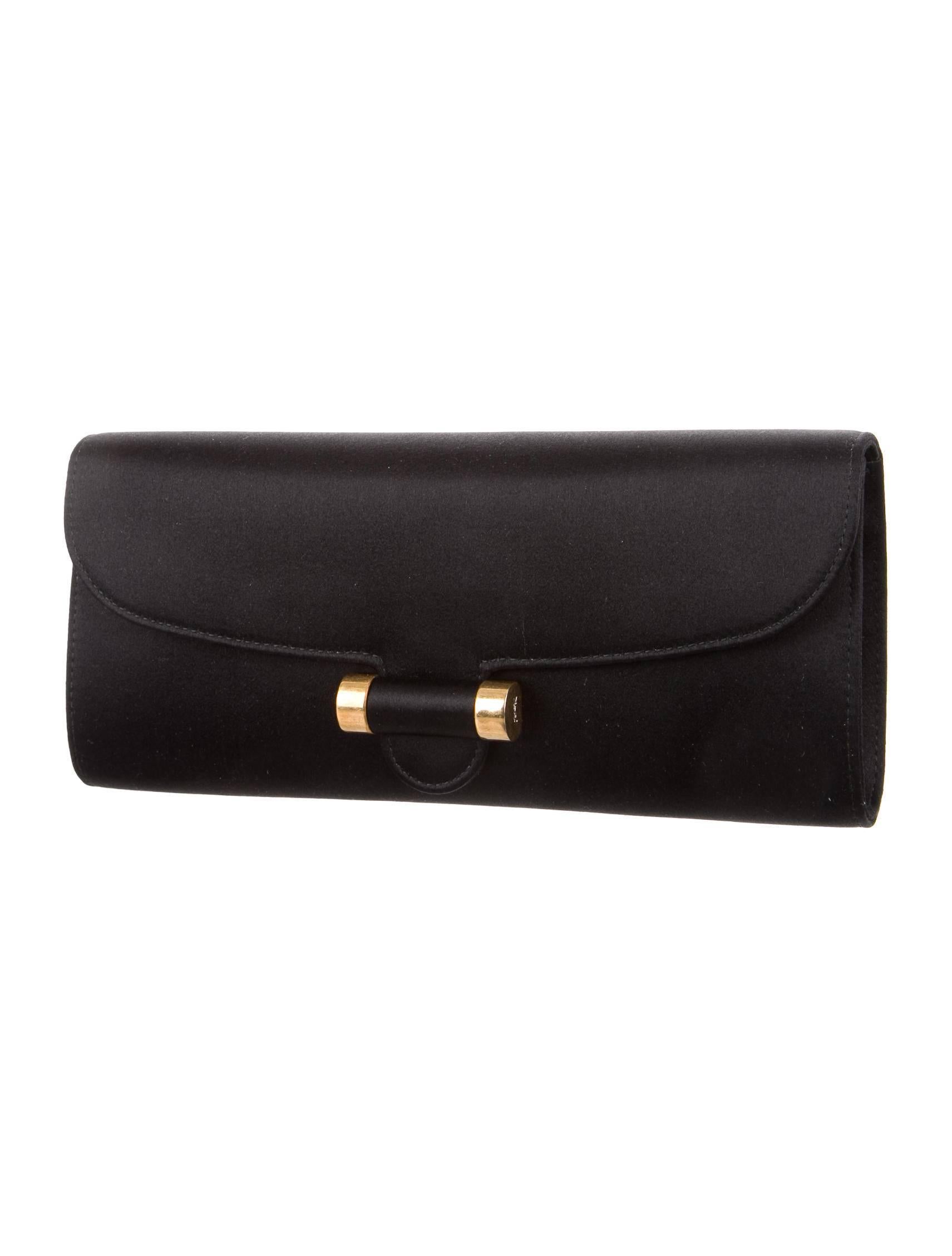 CURATOR'S NOTES

Satin 
Gold tone hardware
Satin lining
Fold-in flap closure 
Measures 9.25" W x 4" H x 1' D 
Includes original Yves Saint Laurent dust bag

Shop Newfound Luxury for authentic Yves Saint Laurent clutch flap bags.