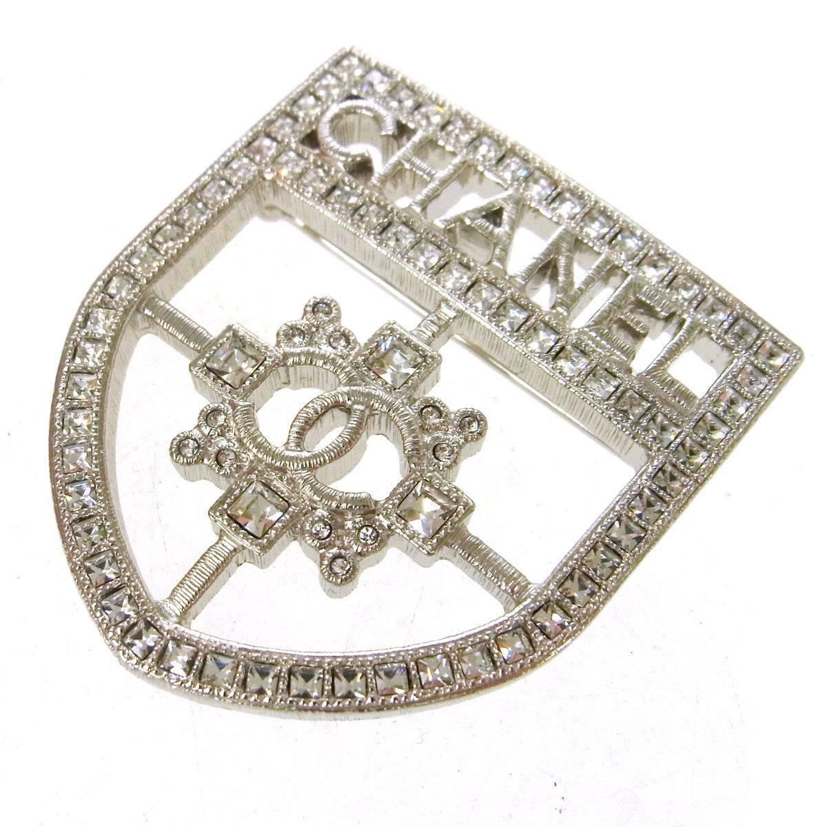 CURATOR'S NOTES 

Chanel Rare CURRENT Silver Crystal Crest Shield Brooch in Box 

Metal
Silver tone
Crystal
Pin closure
Made in Italy
Measures 1.75" W x 2" H 
Includes original Chanel box

Shop Newfound Luxury for authentic pre-owned