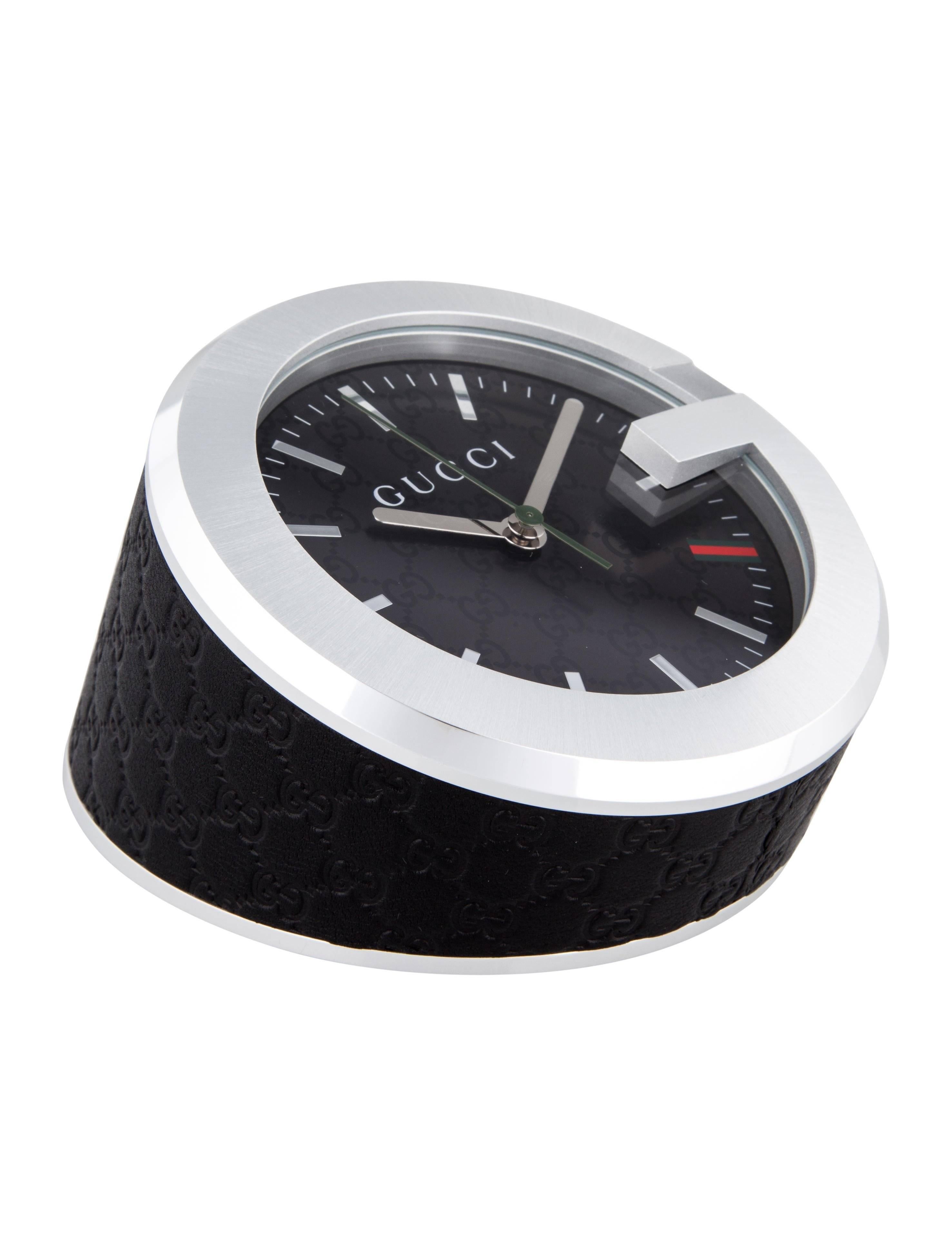 CURATOR'S NOTES

Gucci New Men's Black Leather Stainless Steel Table Desk Clock in Box 

Leather 
Stainless steel 
Black dial
Quartz movement
Signed Gucci underneath
Made in Switzerland
Diameter 4"
Height 3"
Includes original Gucci box,