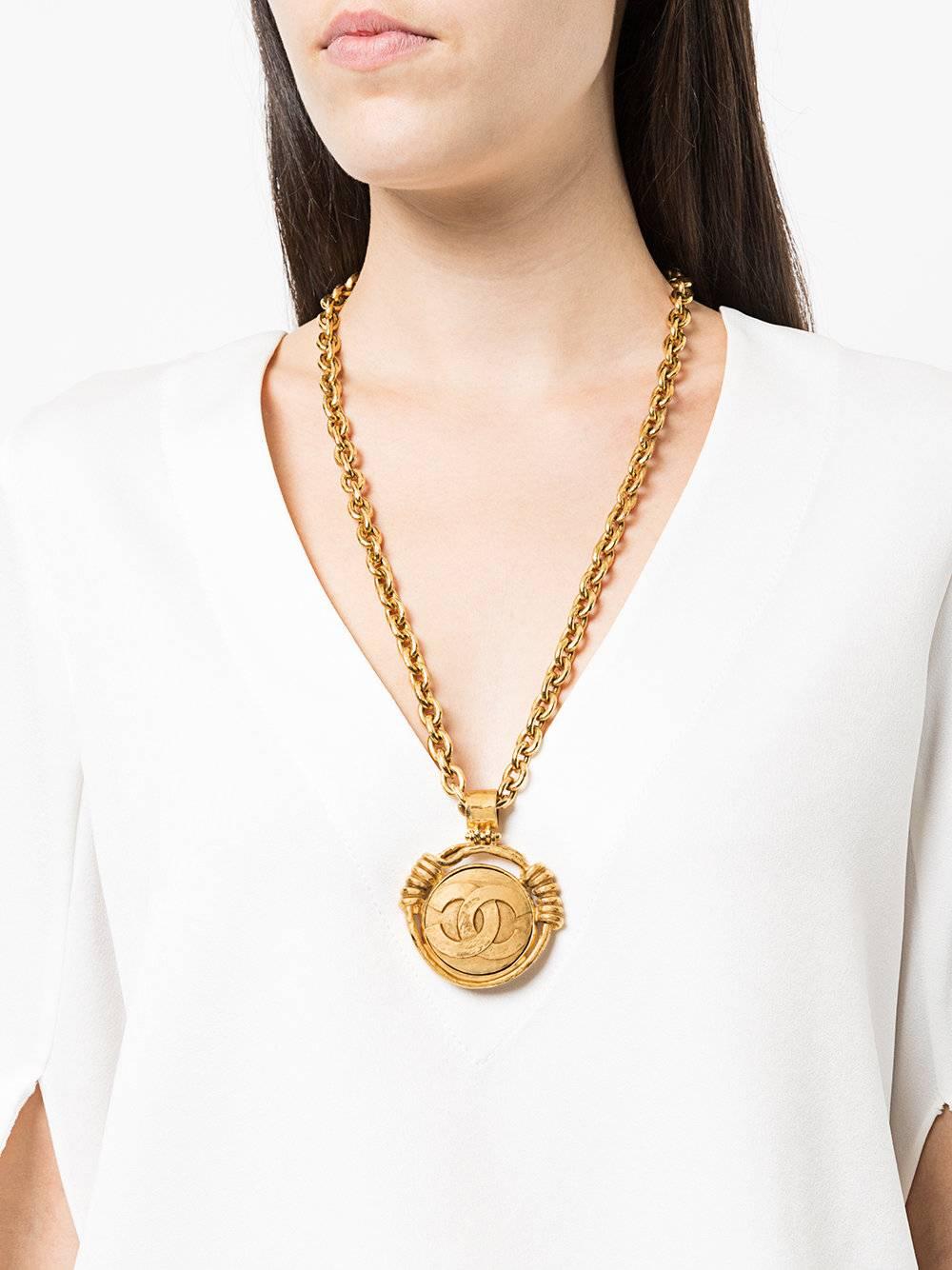 Chanel Vintage Gold Medallion Charm Reverse Mirror Evening Dangle Long Necklace 

Metal
Gold tone
Glass
Lobster closure
Made in France
Charm diameter 2