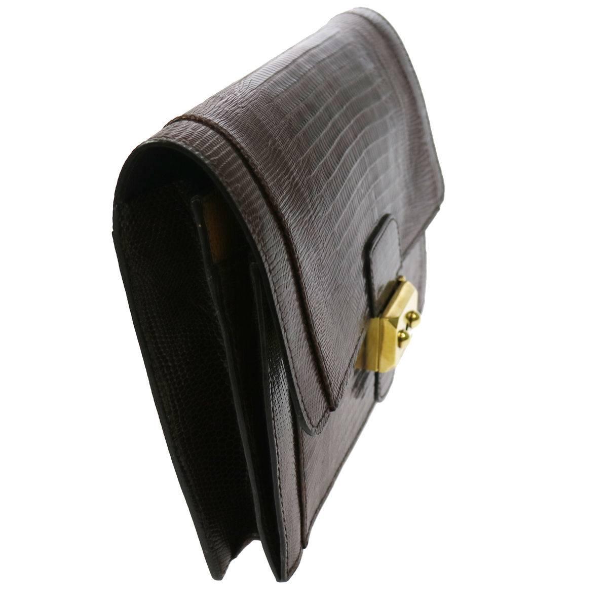 CURATOR'S NOTES

Hermes Chocolate Brown Lizard Leather Gold Envelope Evening Flap Wristlet Clutch Bag  

Lizard
Gold tone hardware
Push lock closure
Leather lining
Made in France
Measures 9.5" W x 6.75" H x 1" D 
Includes original