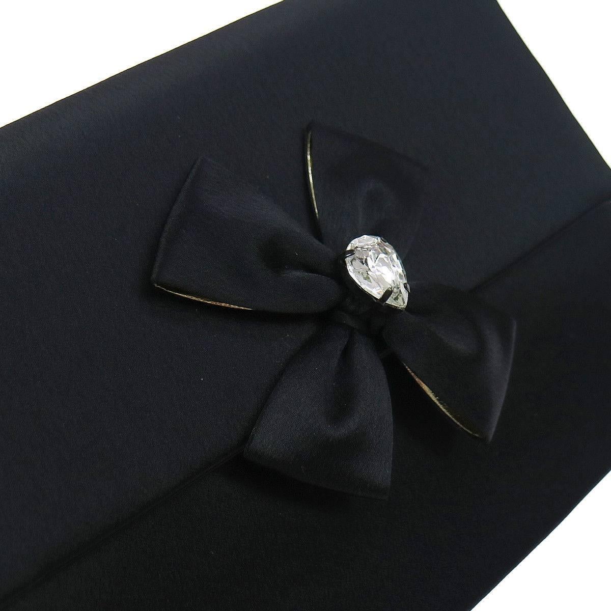 Yves Saint Laurent (YSL) Black Satin Rhinestone Bow Evening Envelope Clutch Bag 

Satin
Rhinestone
Magnetic snap closure
Satin and leather lining
Measures 8" W x 6" H x 1.5" D 
Includes original dust bag