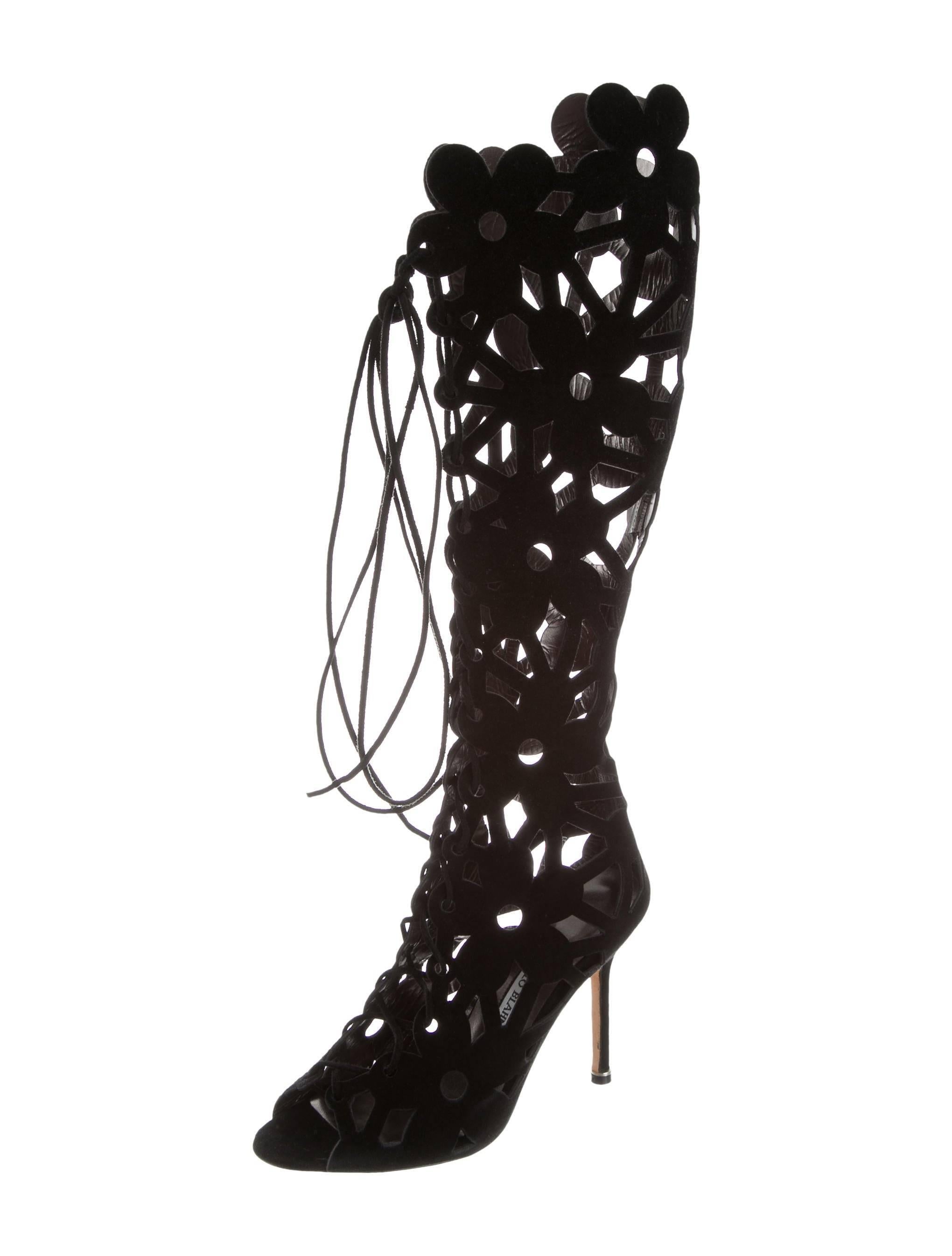 CURATOR'S NOTES

ONLY PAIR!  Manolo Blahnik New Sold Out Black Suede Cut Out Knee High Boots in Box  

Size 36.5
Suede
Lace-up closure
Made in Italy
Circumference 14.25"
Shaft 15.75"
Heel height 4.25"
Includes original Manolo Blahnik