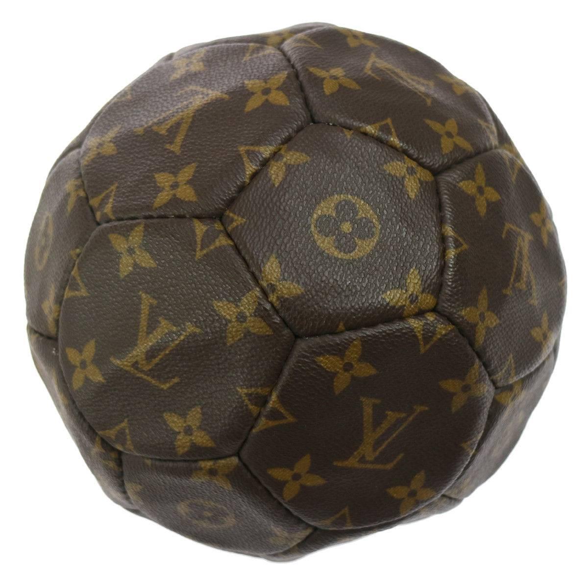 Louis Vuitton Monogram Collector's Soccer Ball in Leather Carrying Strap Holster 

From France World Cup 1998
Monogram canvas
Leather
Signed France 1998
Date codes present 
Made in France
Diameter 7 "
Carrying strap drop 14"
Includes