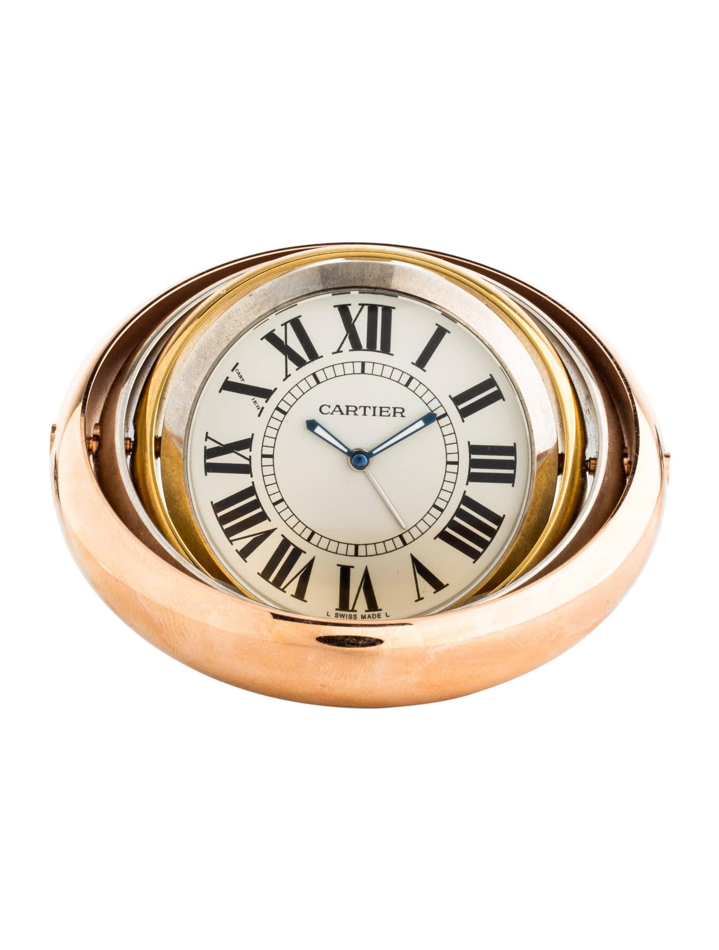 CURATOR'S NOTES

Cartier Tri Tone Silver Rose Gold Men's Round Rotating Travel Desk Table Clock   

Stainless steel
Gold, silver and rose gold tone 
Quartz movement
Rotating axis
Swiss made
Diameter 3